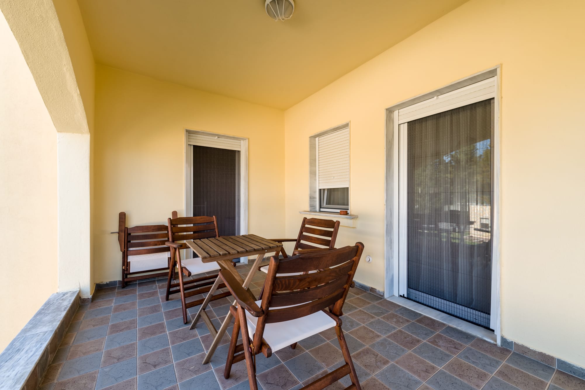 a patio with chairs and table