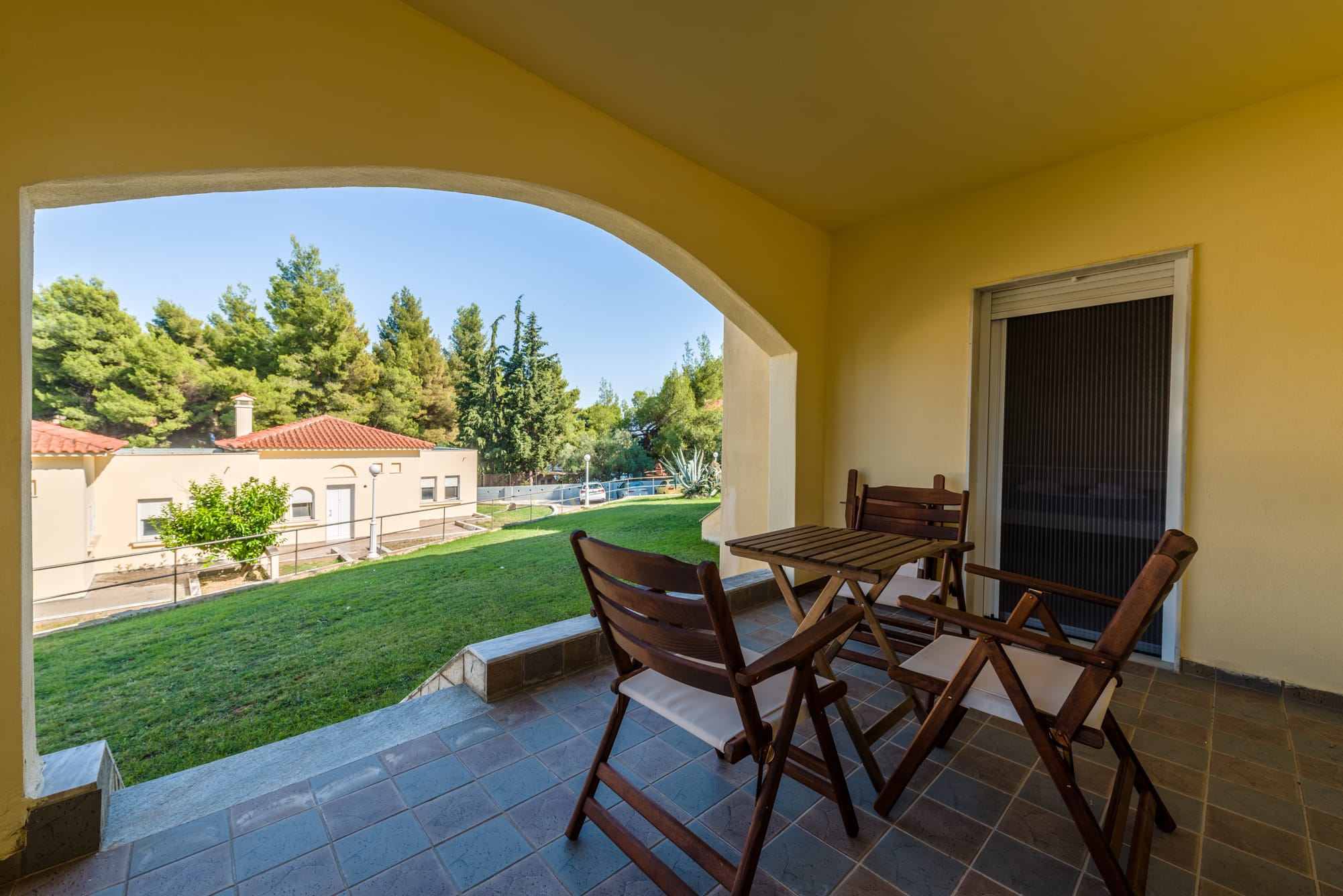 a patio with chairs and a table