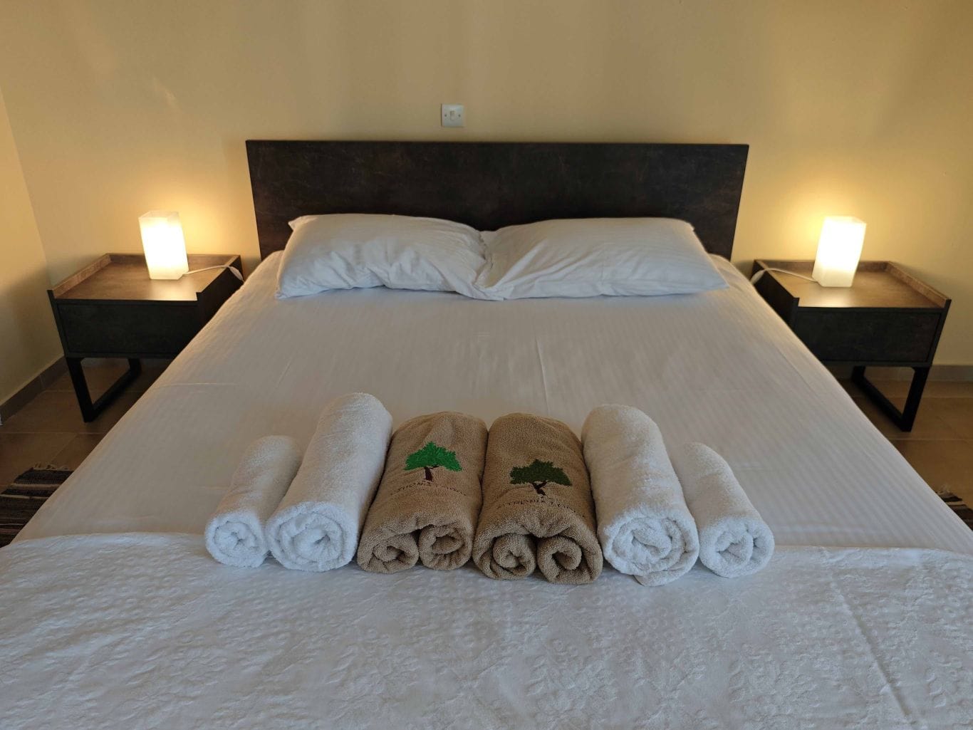 a bed with white towels on it