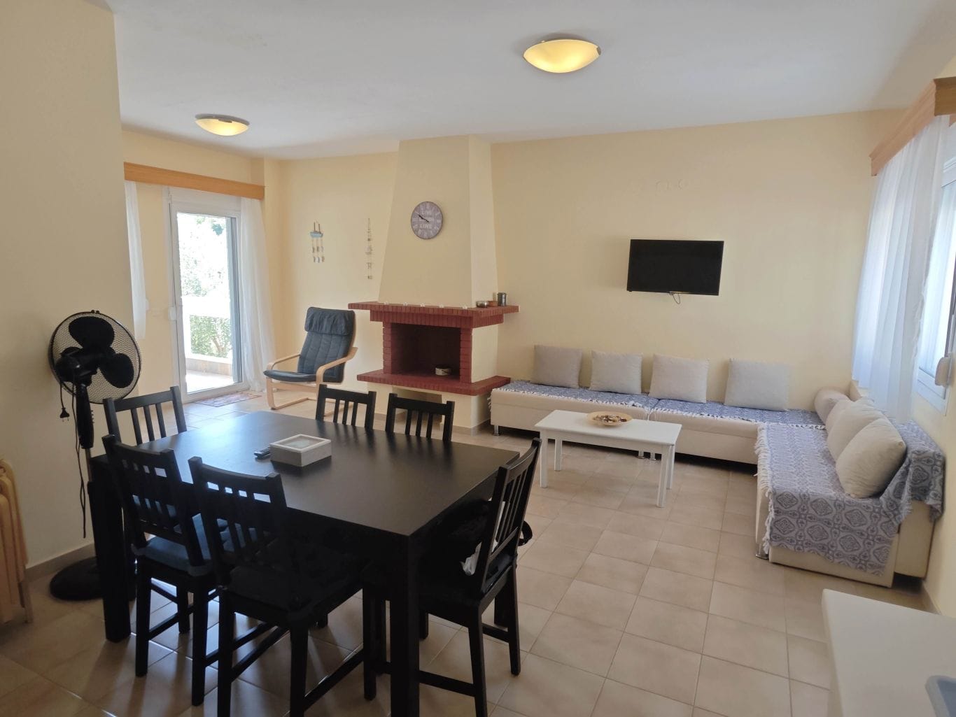 a living room with a table and chairs