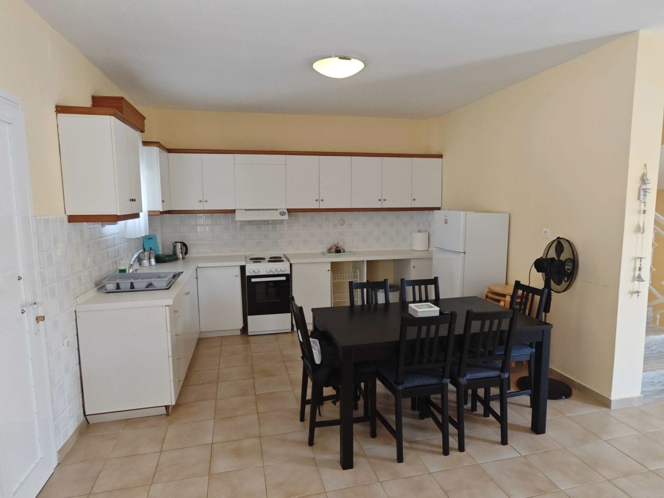 a kitchen with a table and chairs
