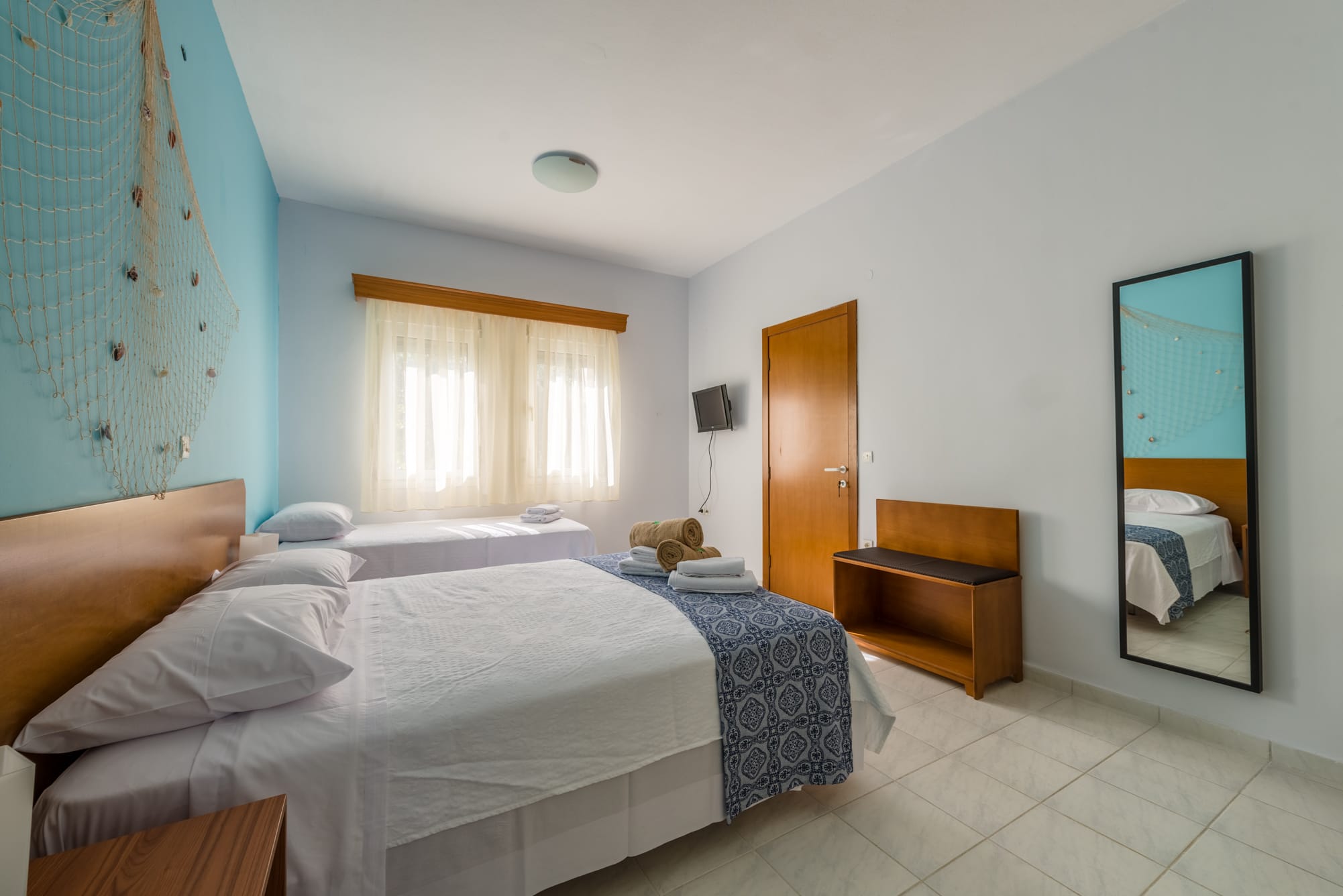 a room with two beds and a tv