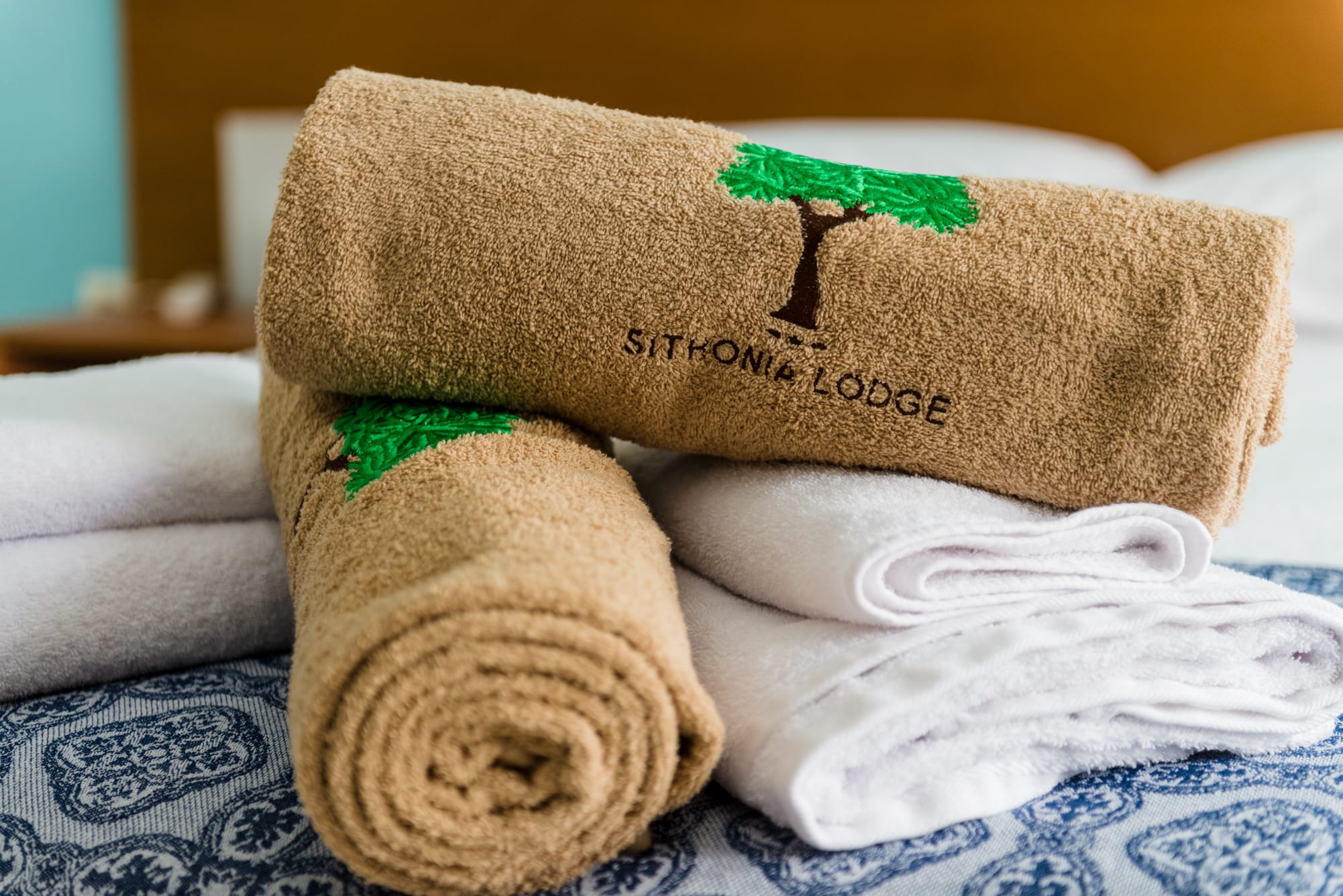 a stack of towels on a bed
