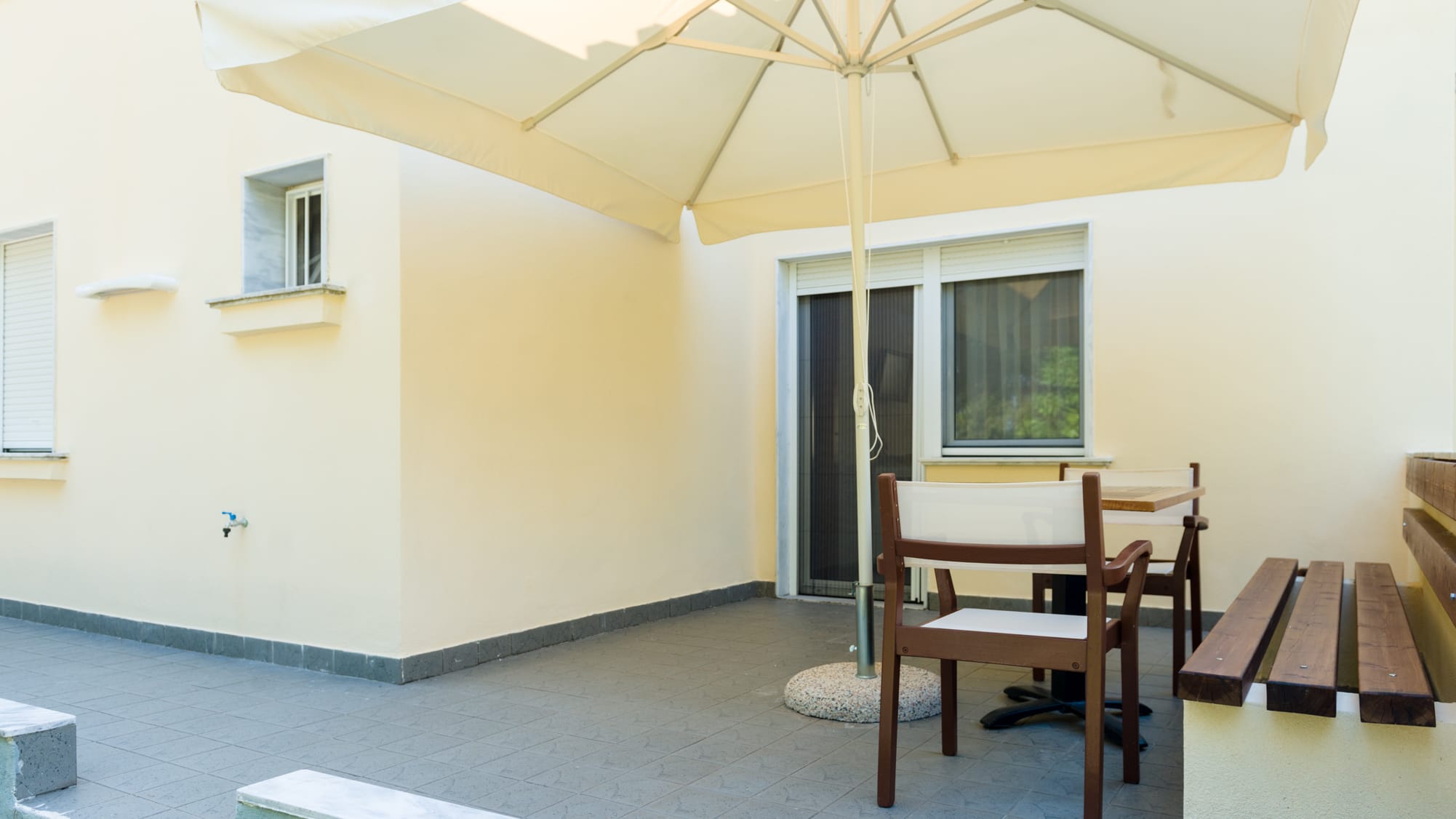 a patio with a table and chairs