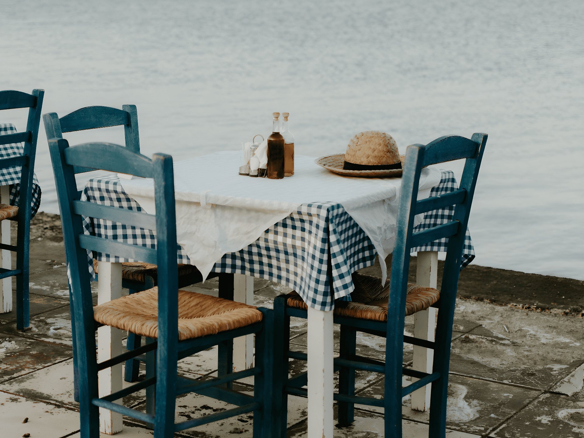 a couple of chairs and a table on a beach