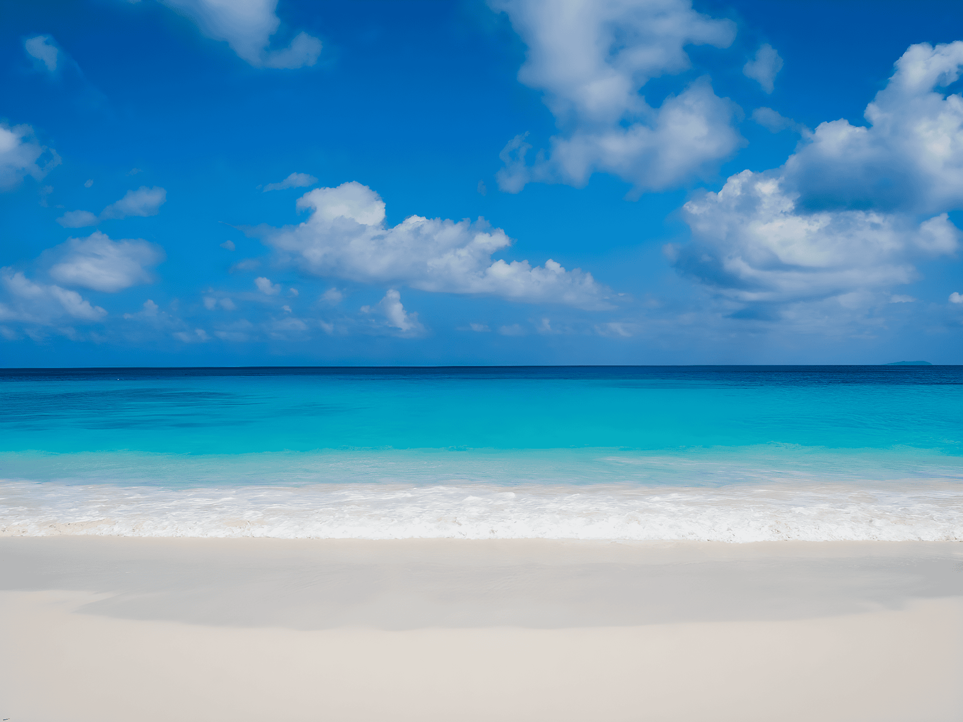 a beach with blue water and clouds