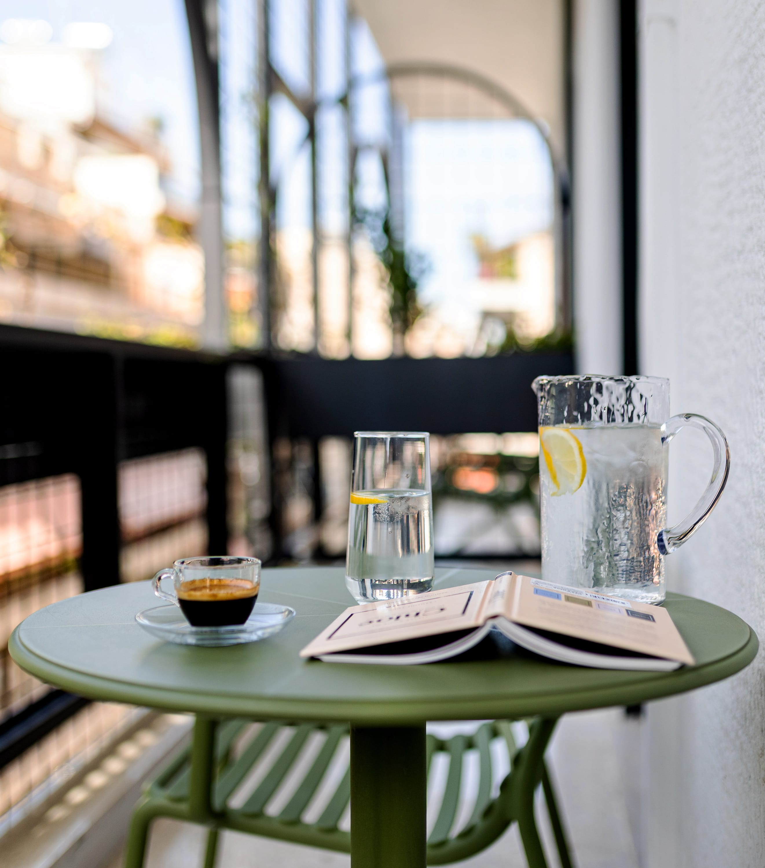 a table with glasses and a plate of food on it