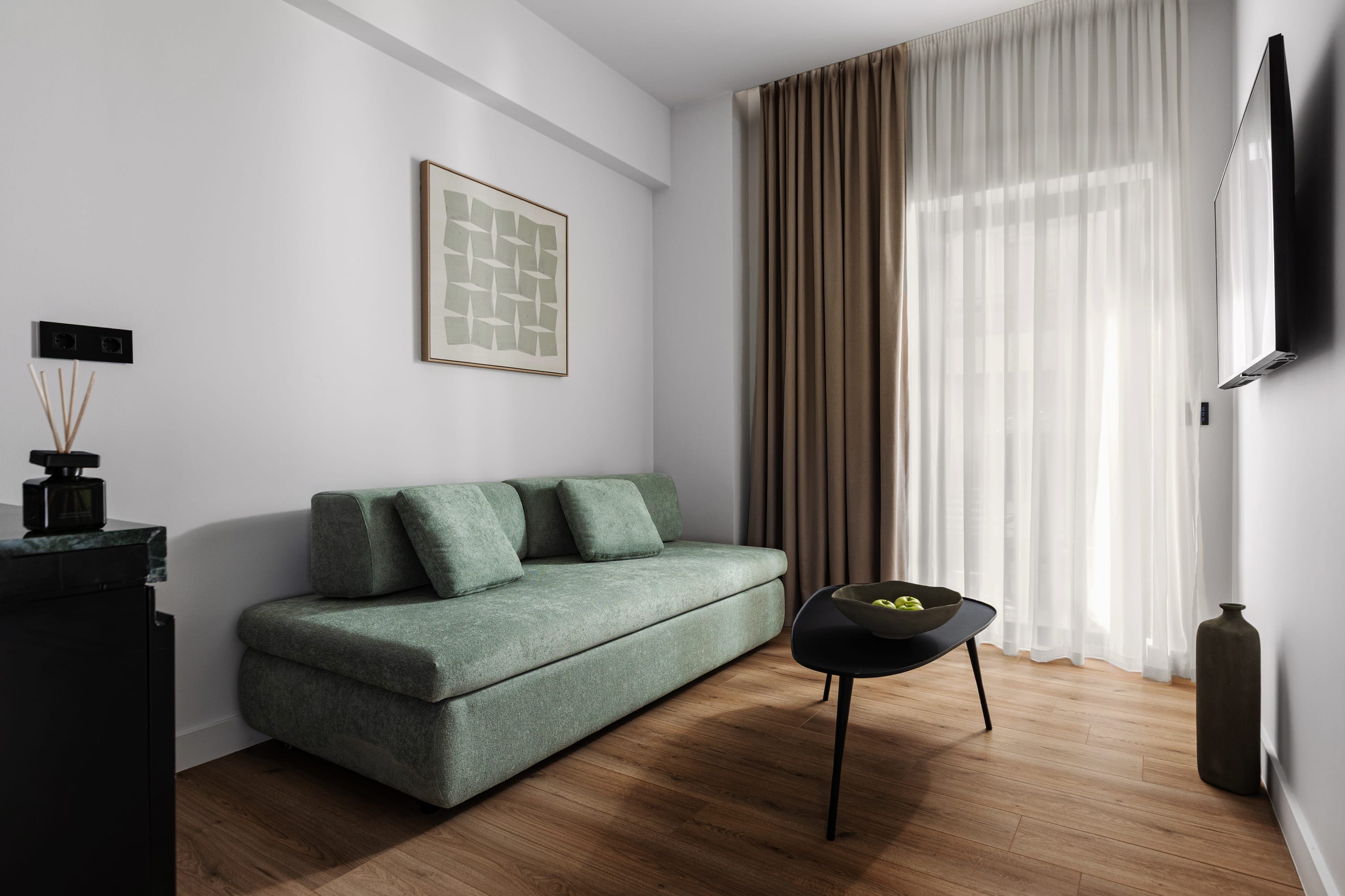 a living room with a green couch