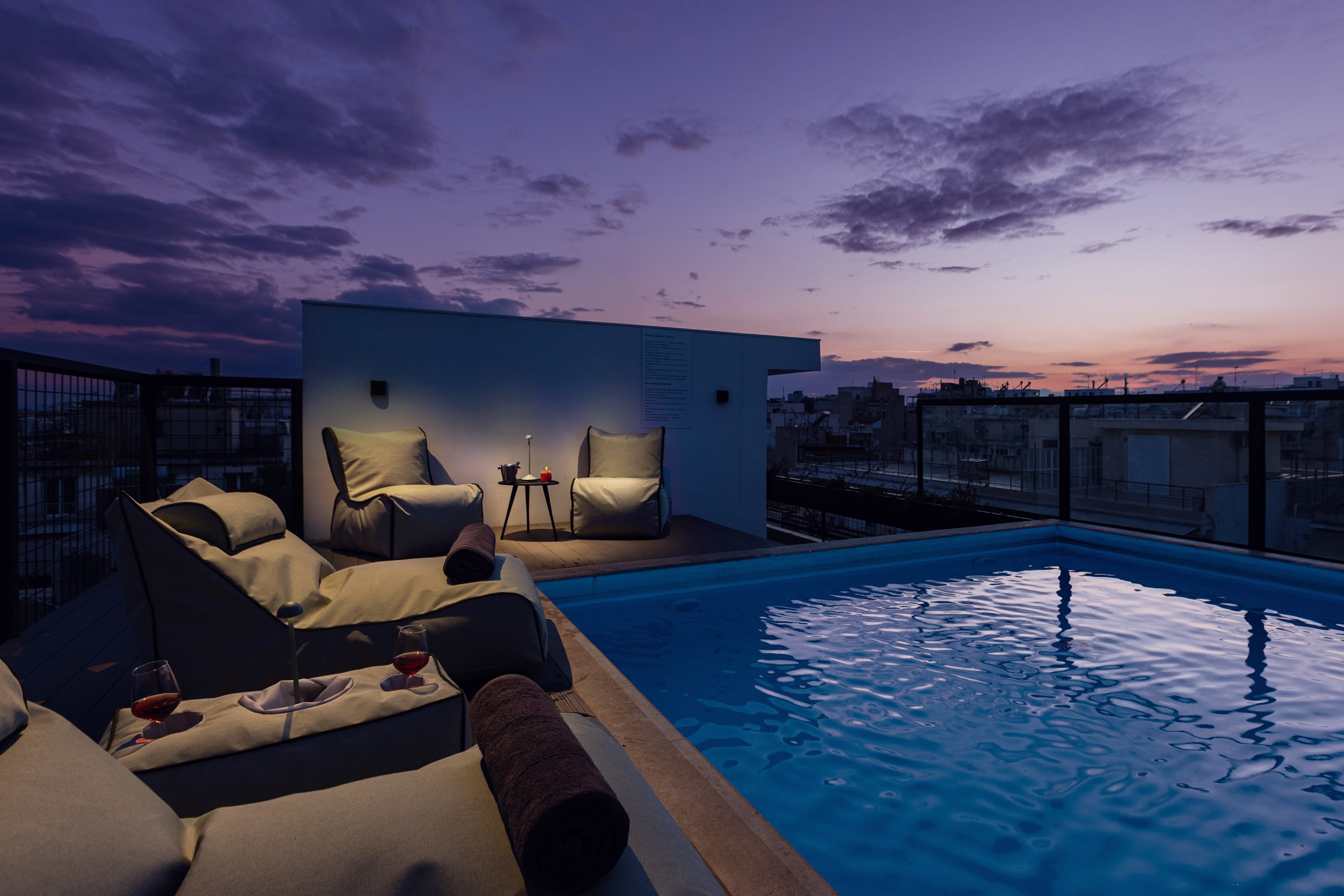 a person sitting on a couch by a pool