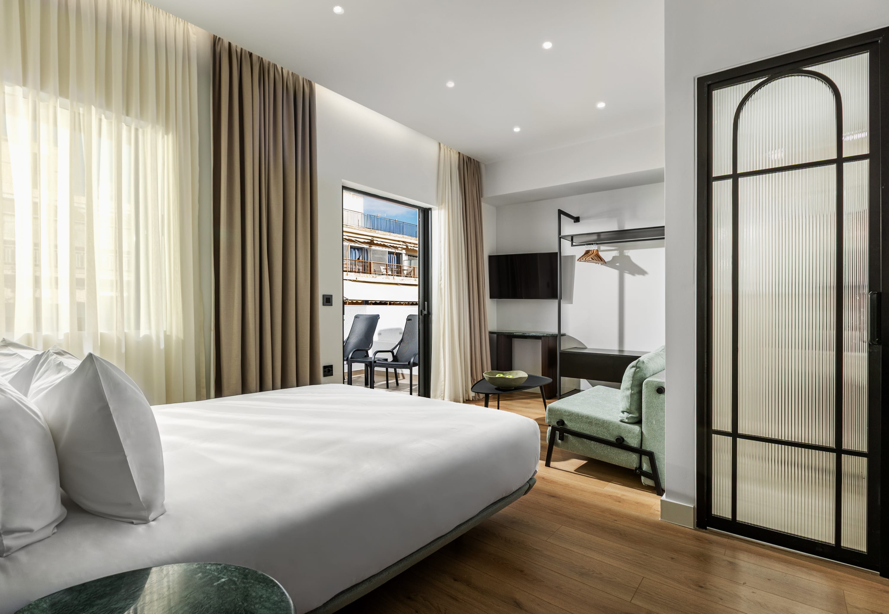 a bedroom with a large glass door