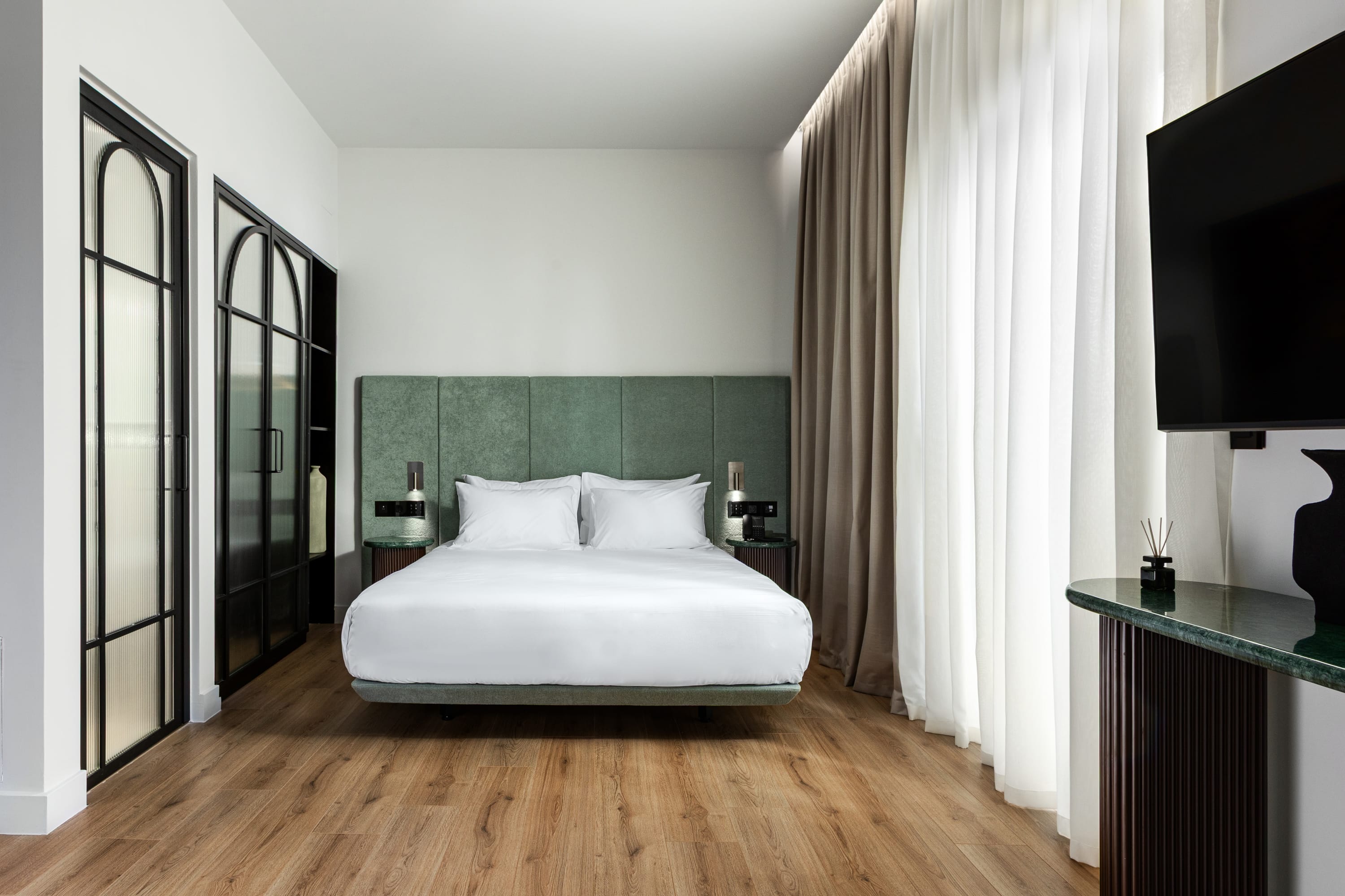 a bedroom with a bed and a tv