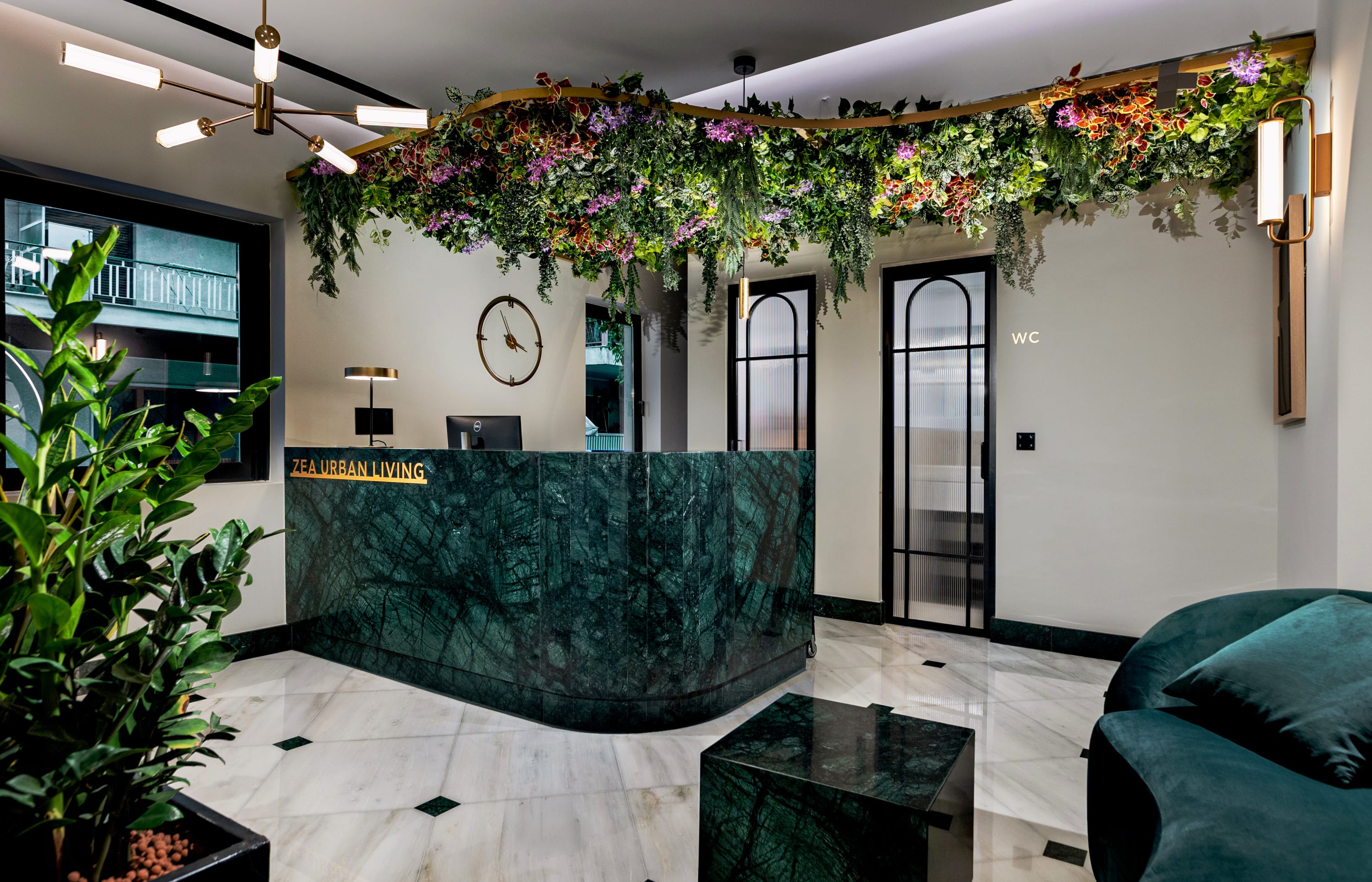 a room with a large planter and a glass table with flowers
