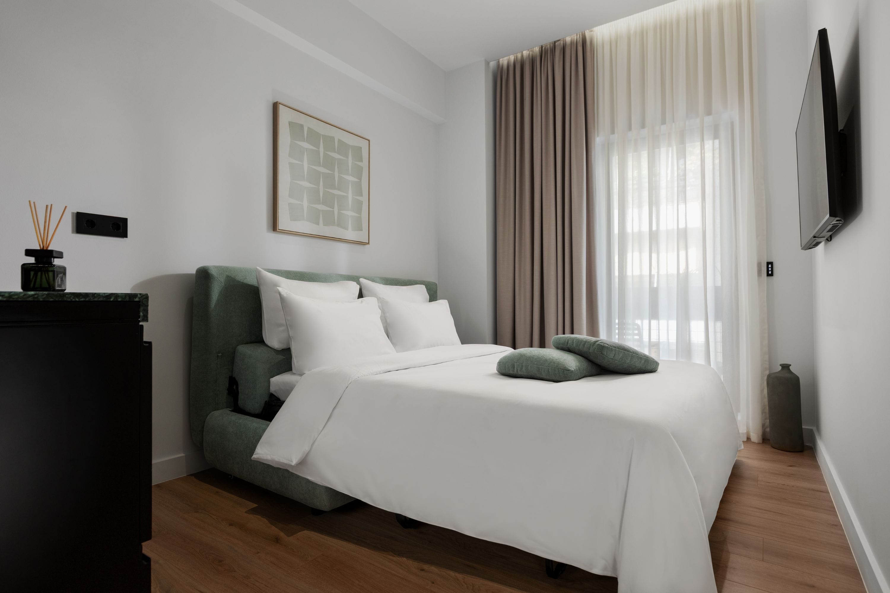 a bed with pillows and a bed frame in a room