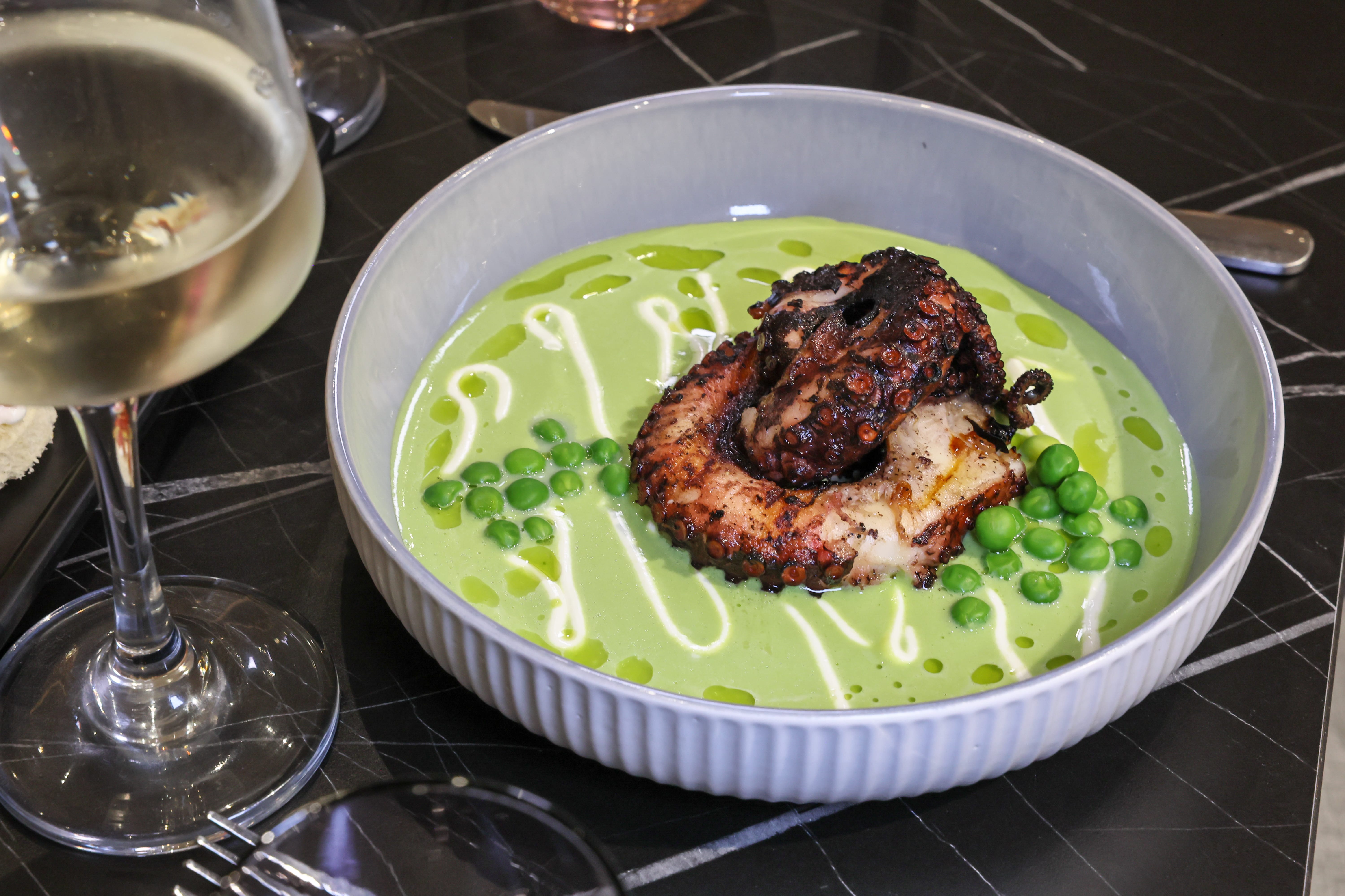 a bowl of soup with a octopus on it