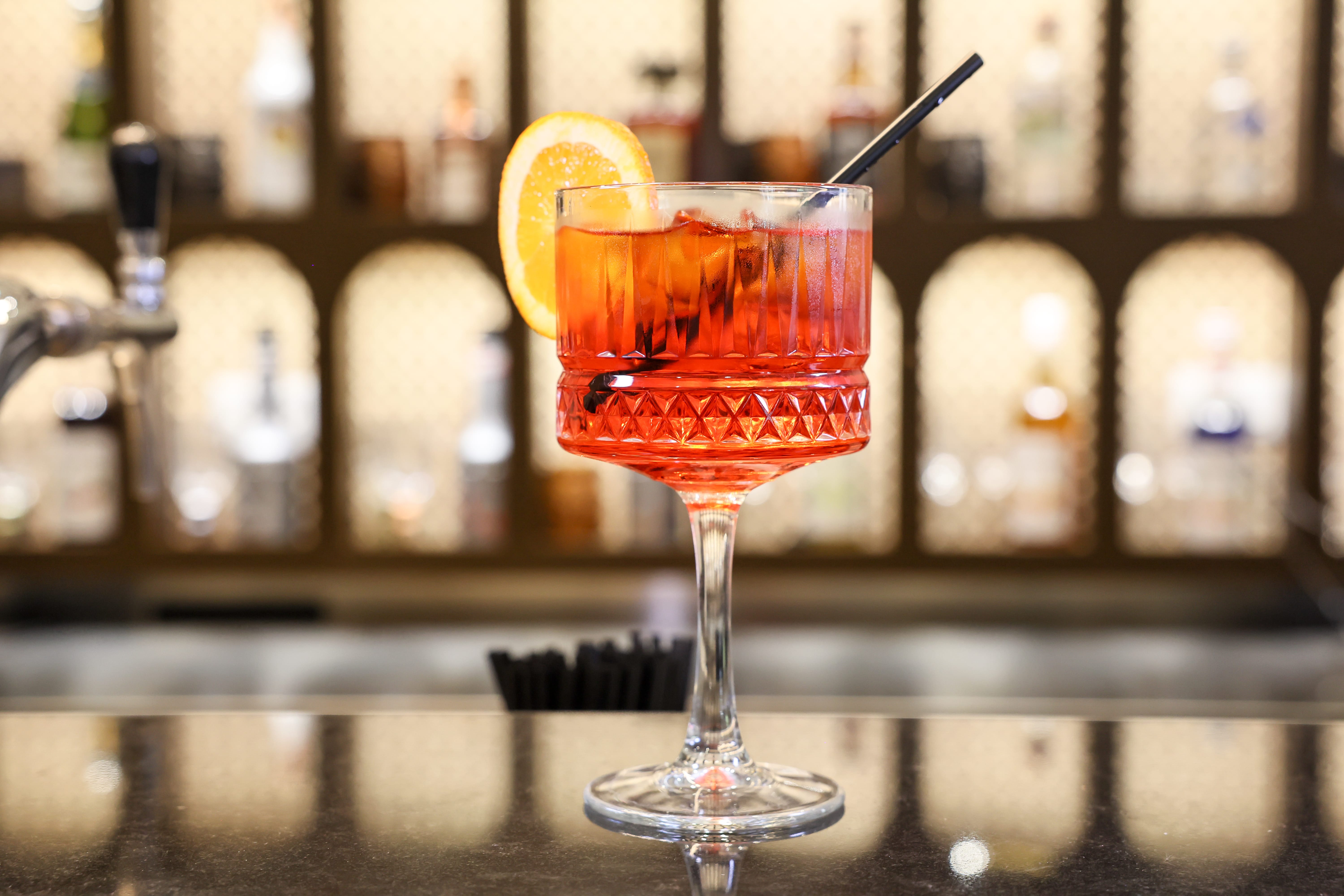 a glass with a drink and a straw