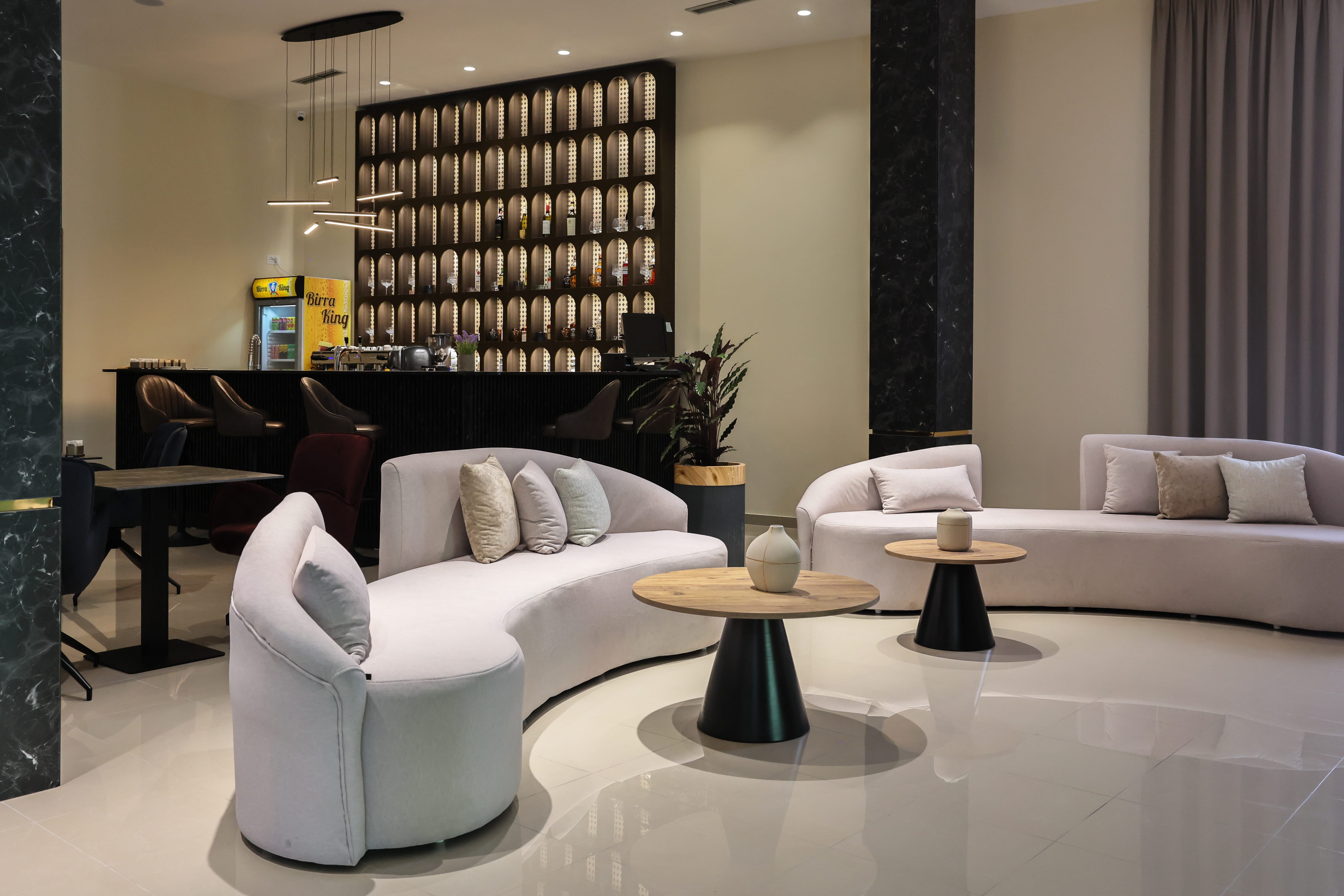 a room with white furniture and a black table