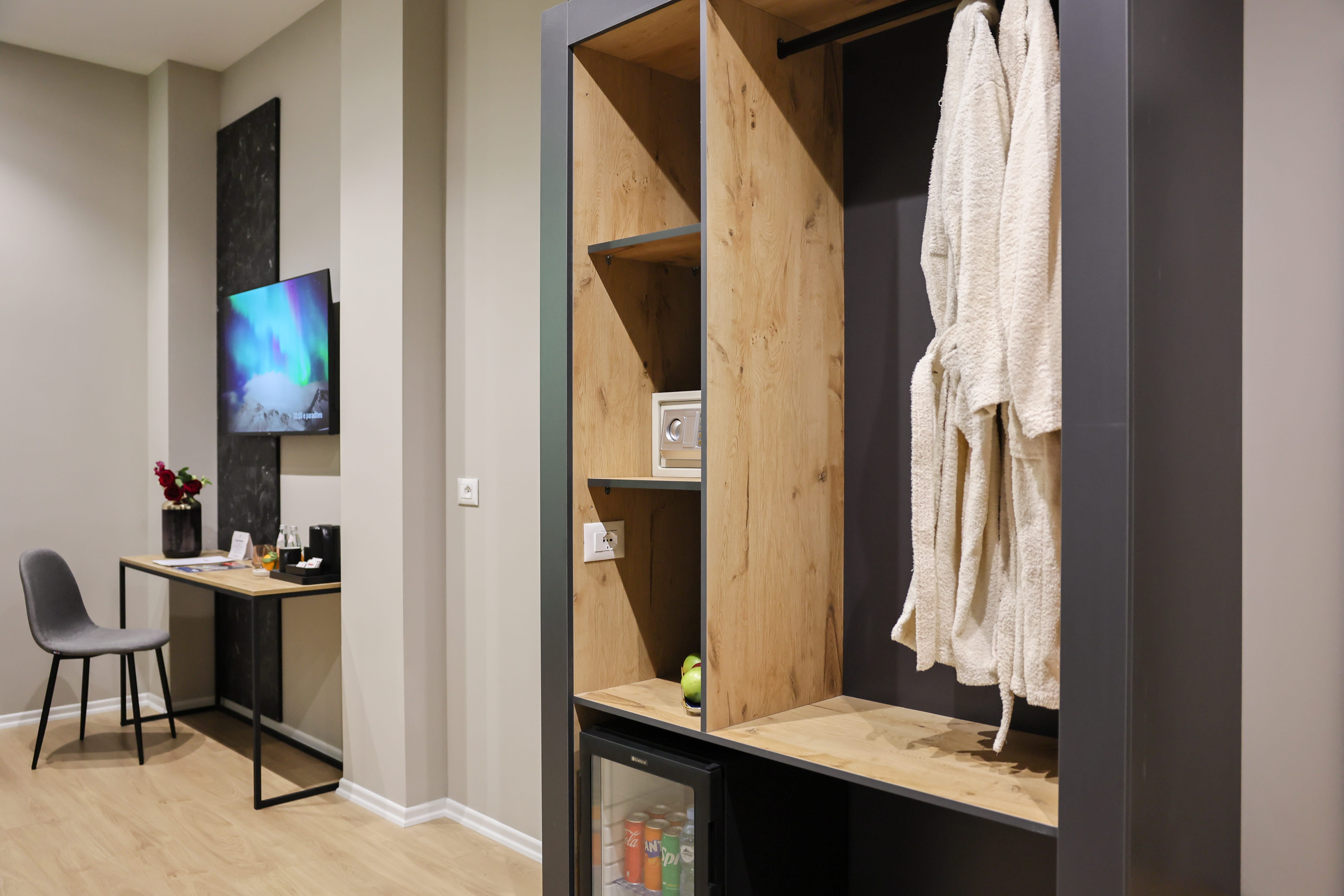 a room with a desk and a tv