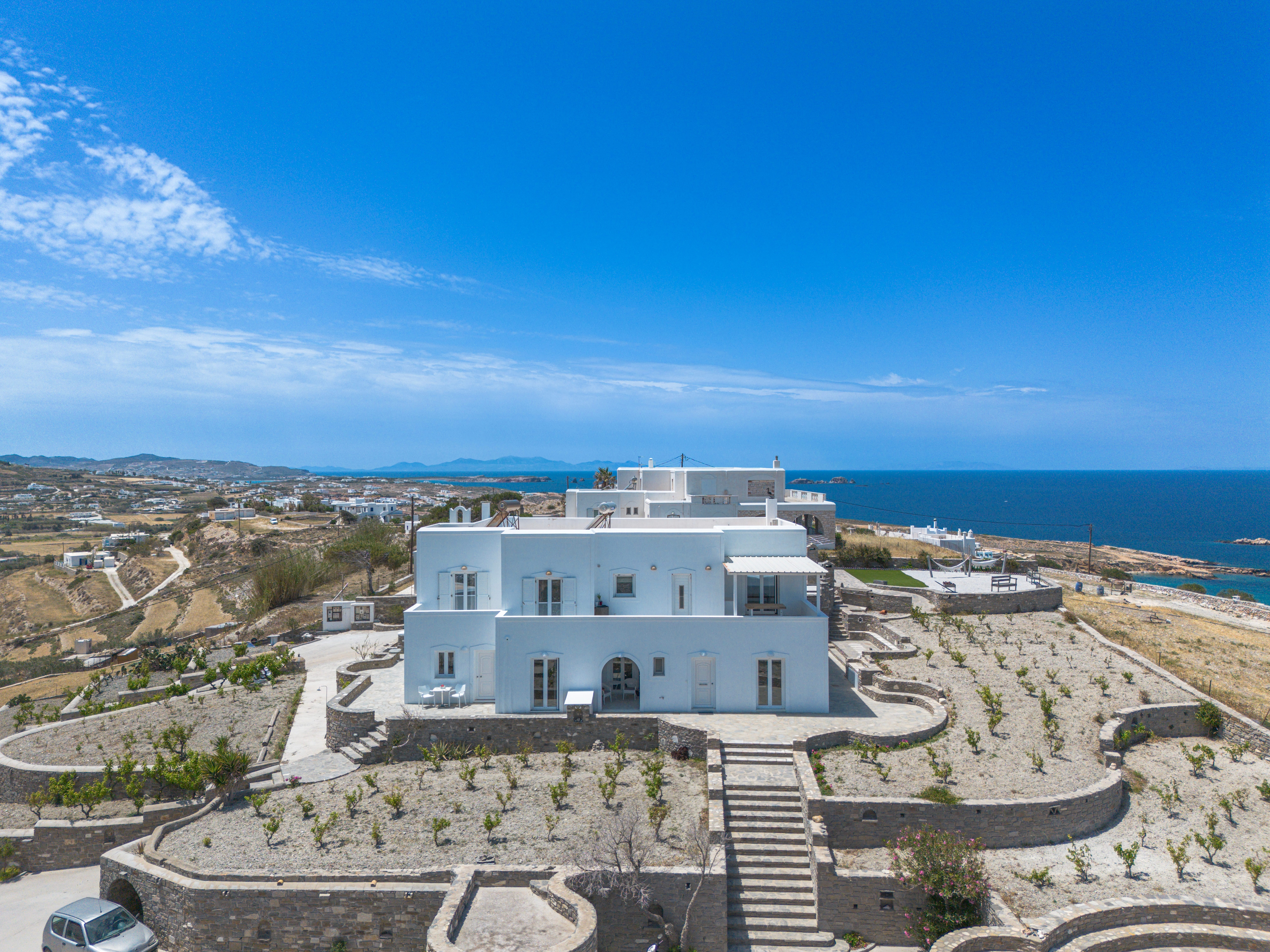 a building on a hill overlooking the ocean