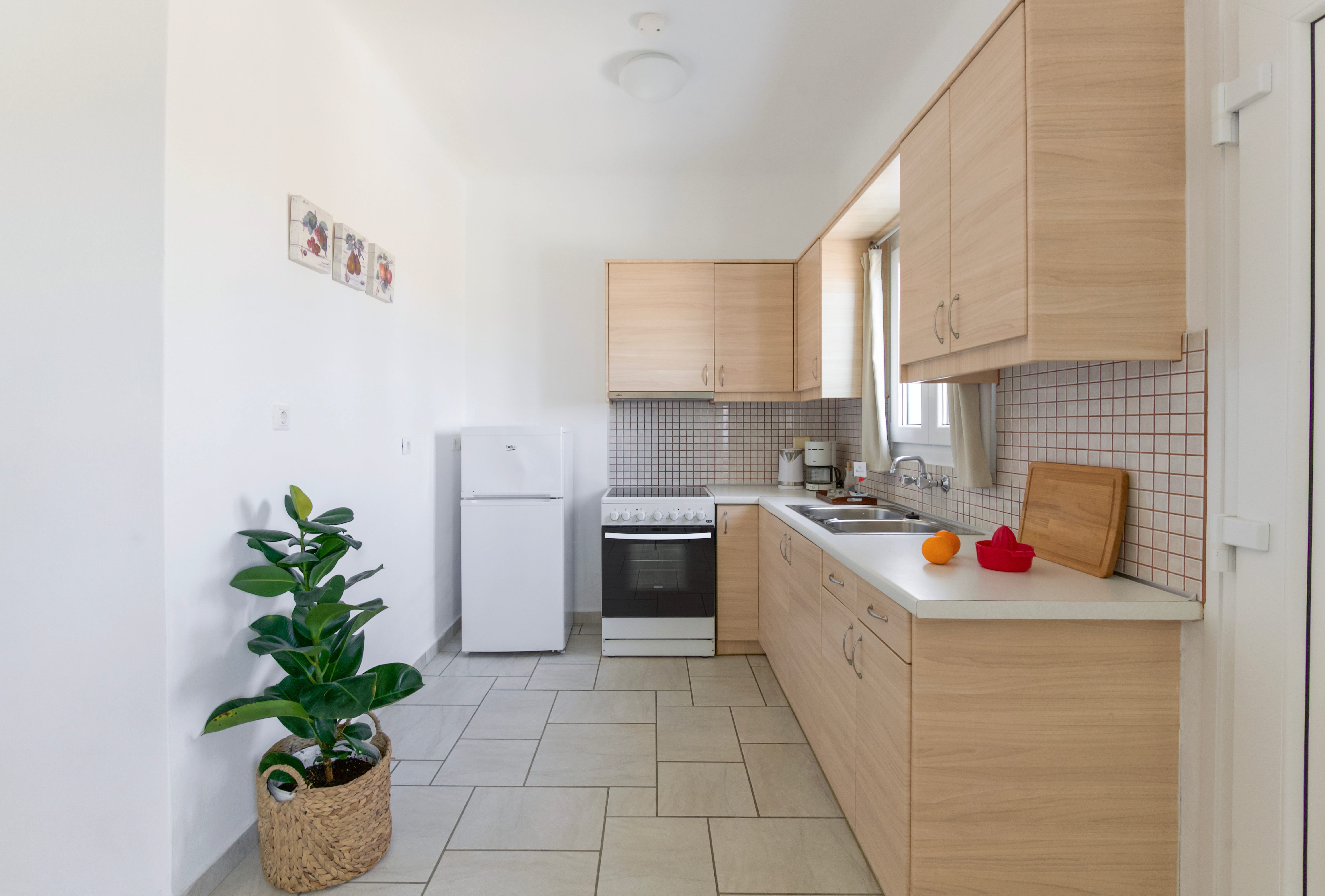 a kitchen with white tiles