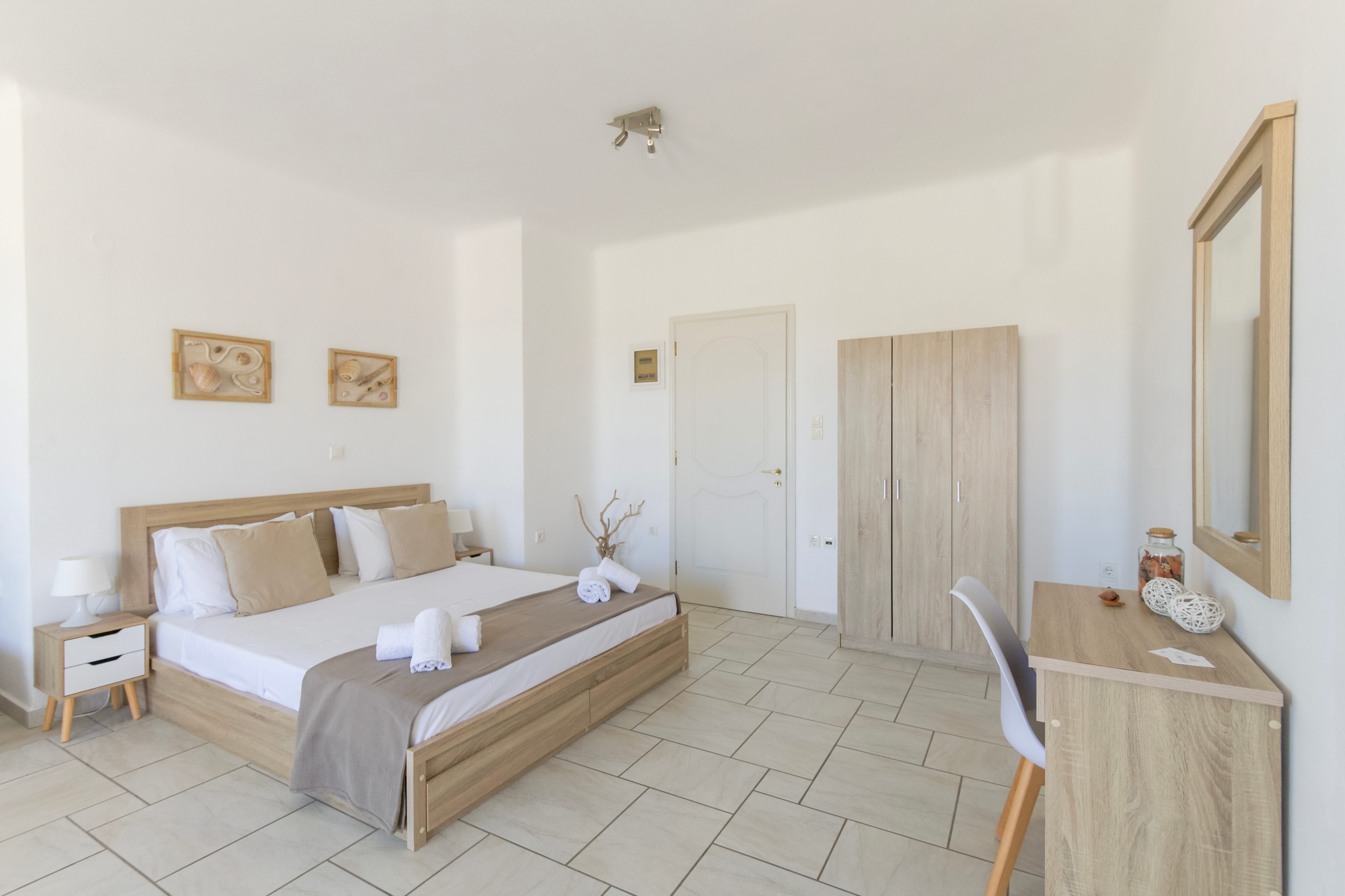 a bedroom with a bed and chairs