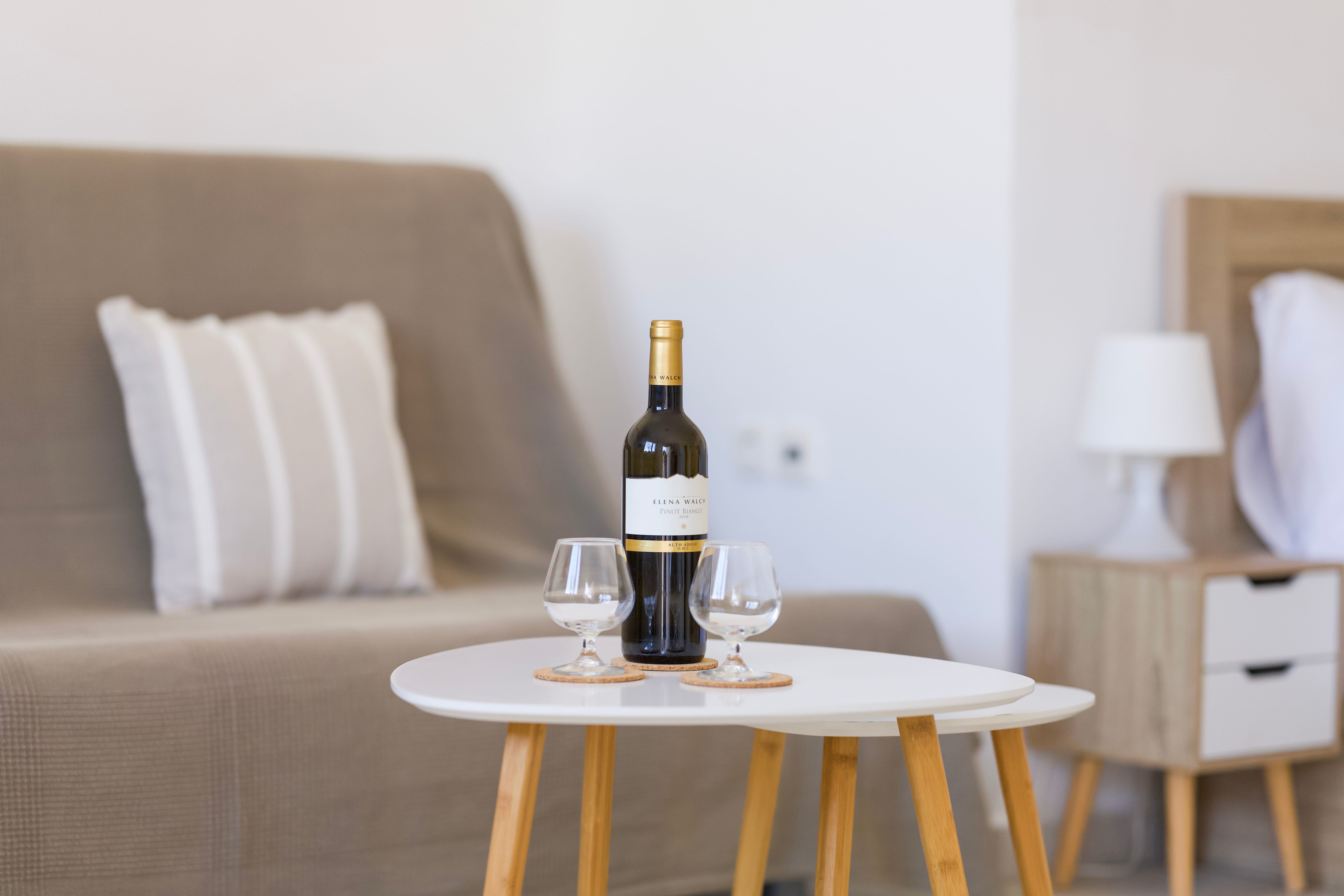 a wine bottle and glasses on a table