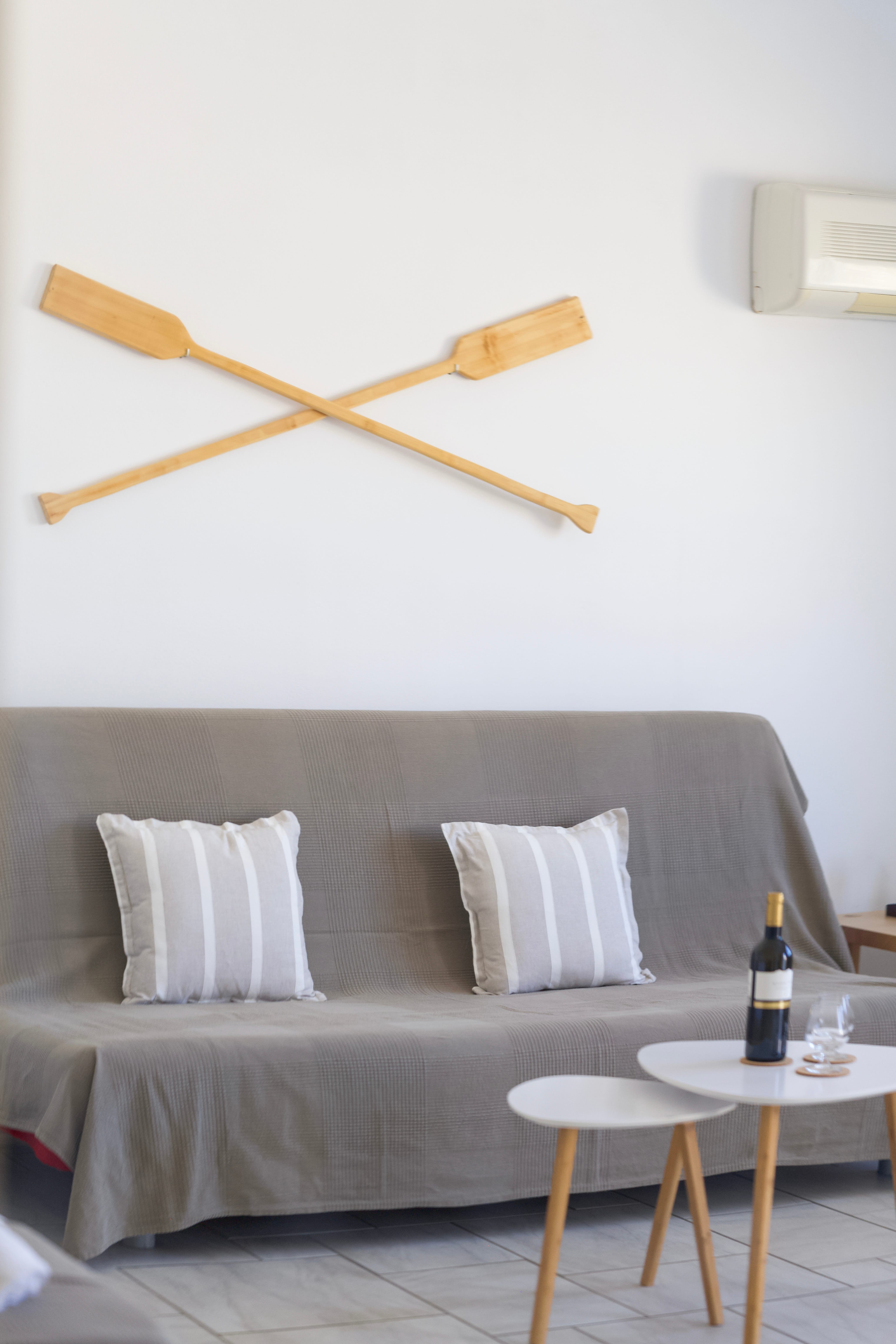 a couch with a table and a bottle of wine on it