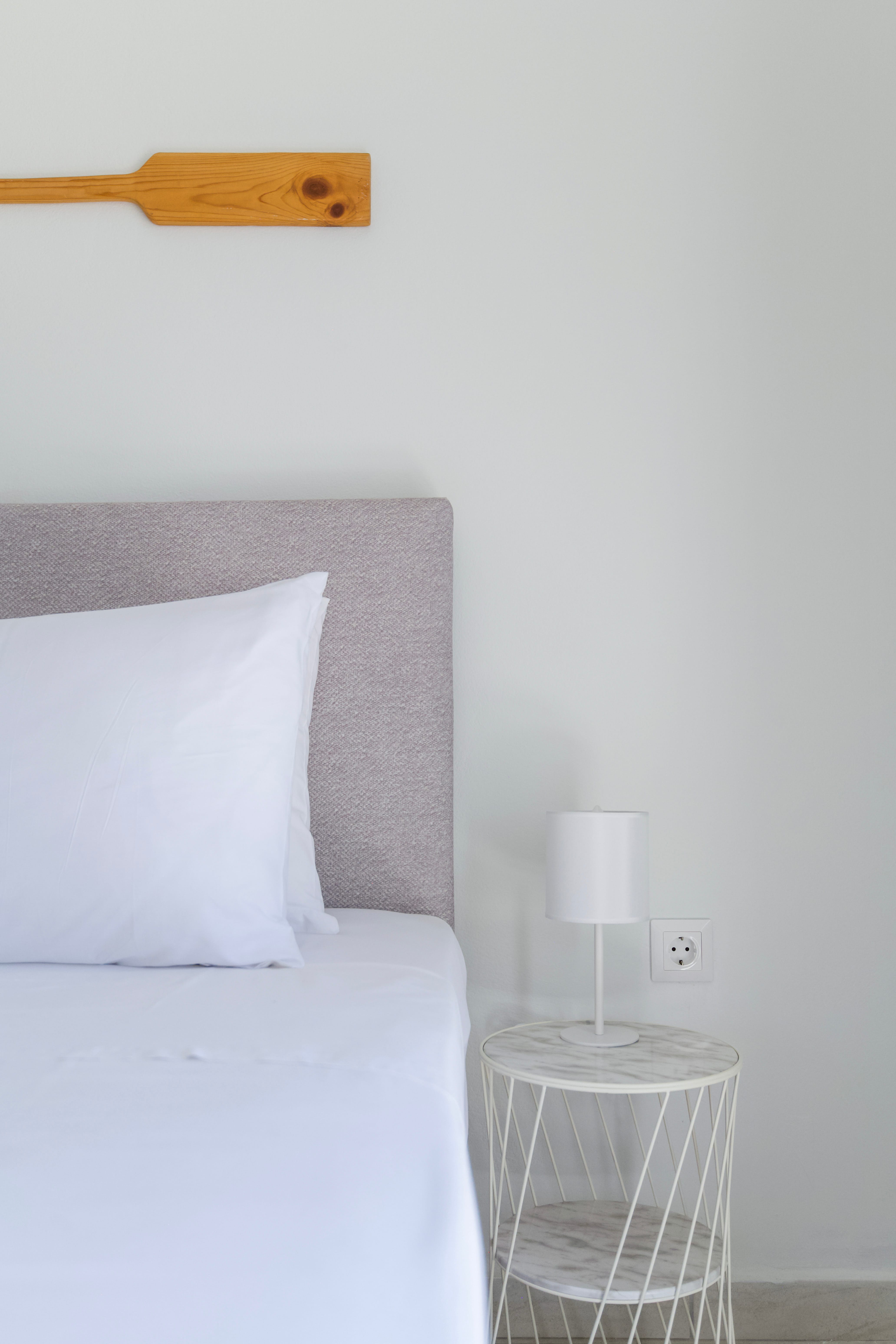 a bed with a lamp on the side