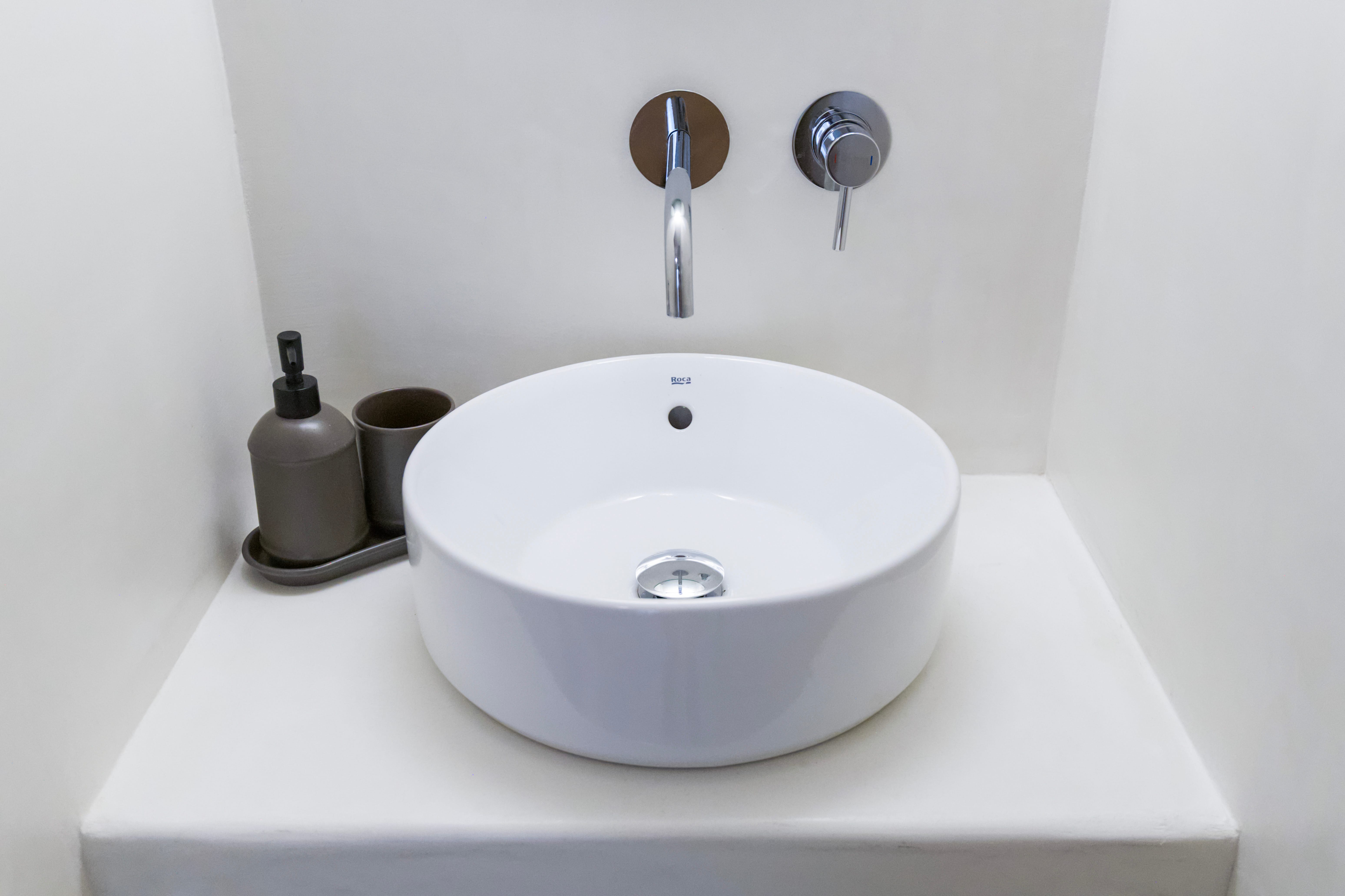 a white sink with a faucet