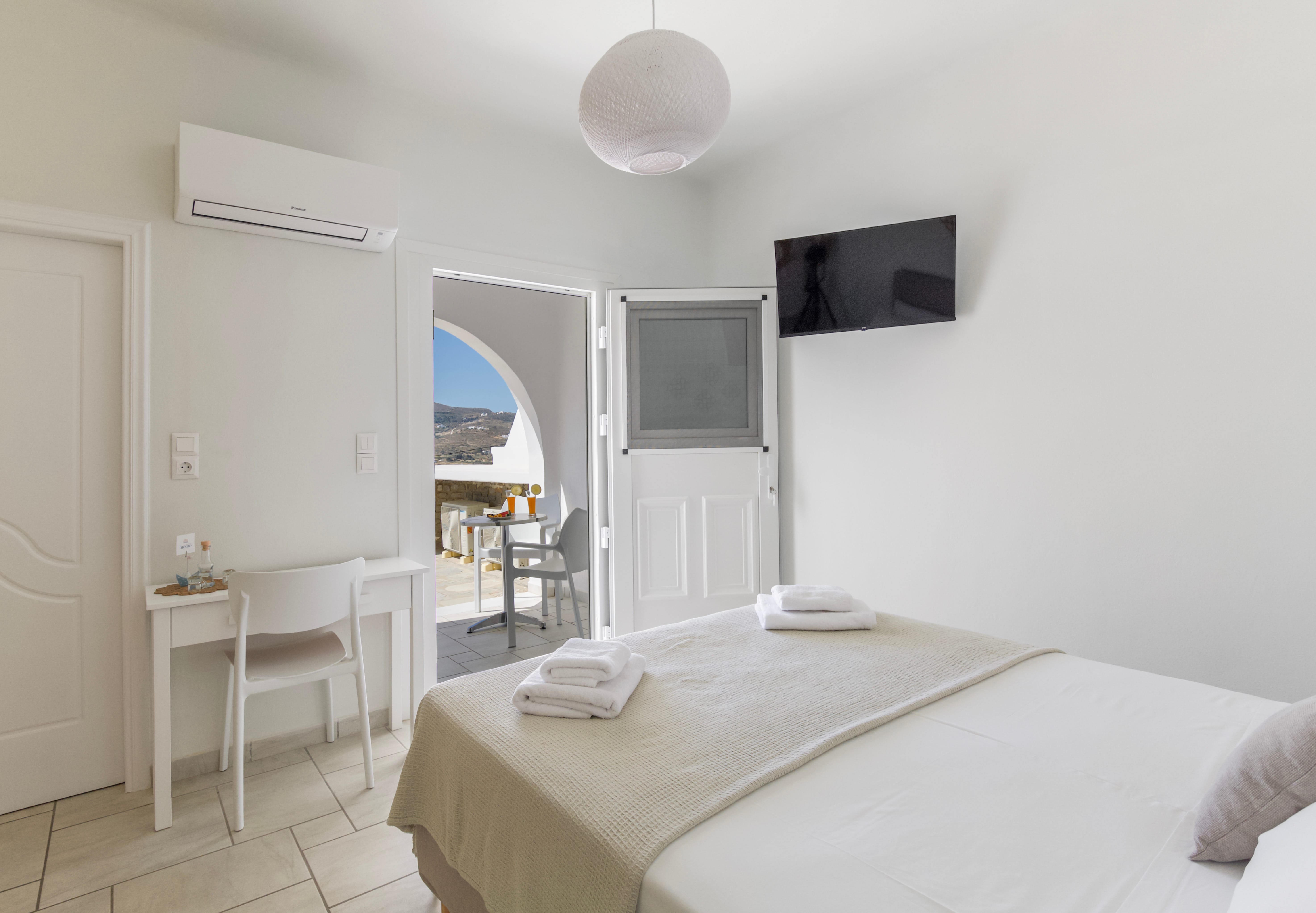 a bedroom with a bed and a television