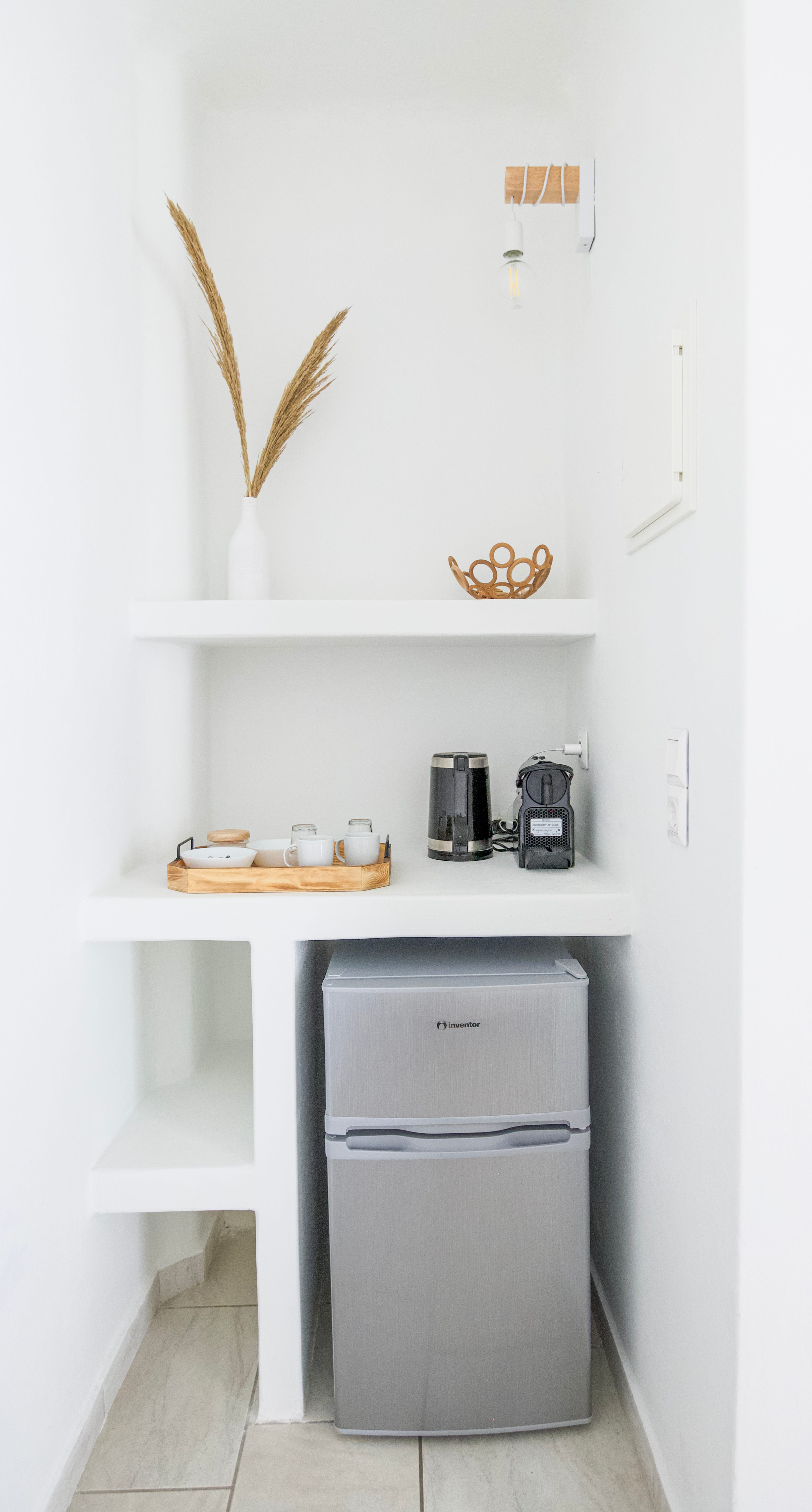 a white shelving unit with objects on it