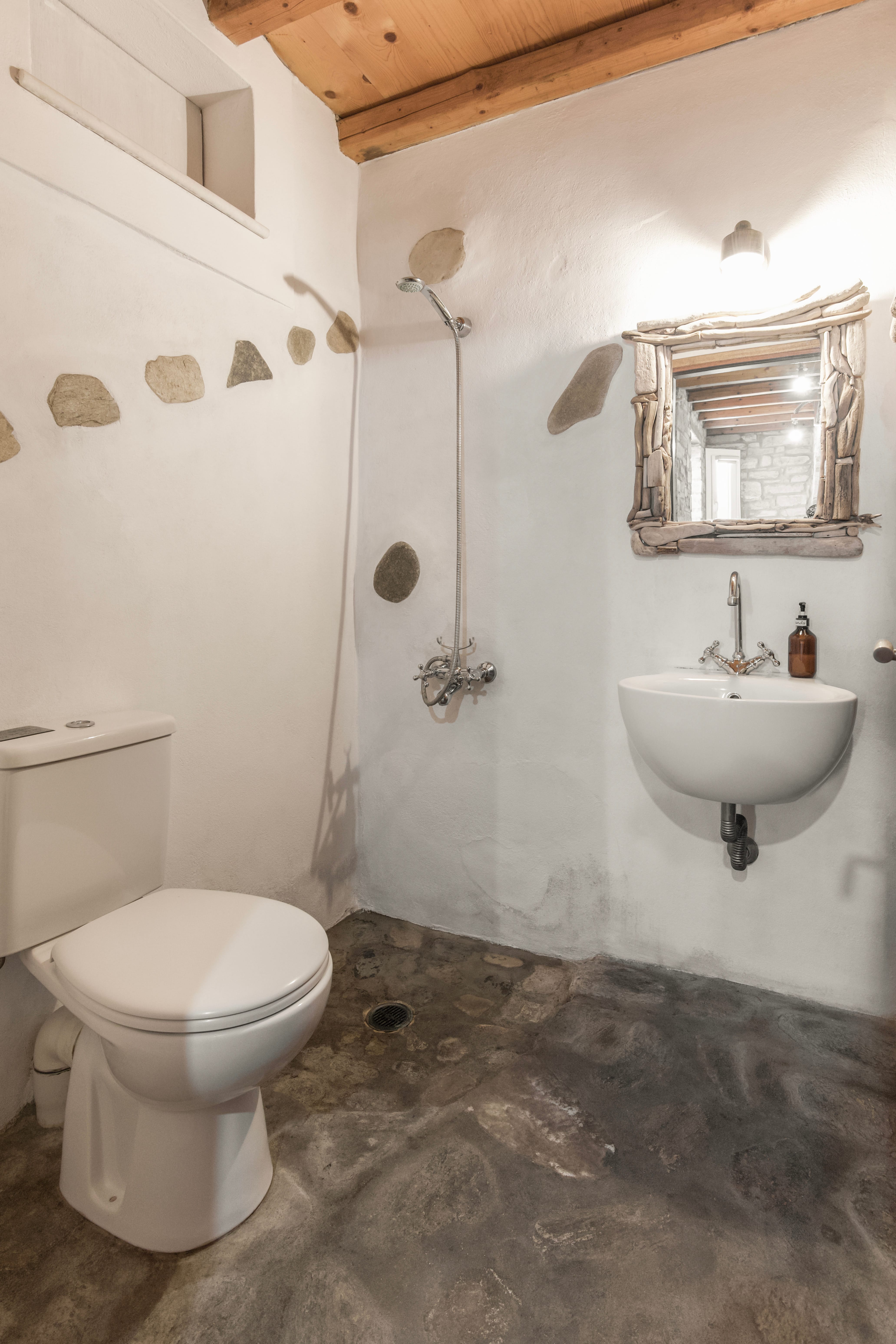 a bathroom with a sink toilet and a mirror