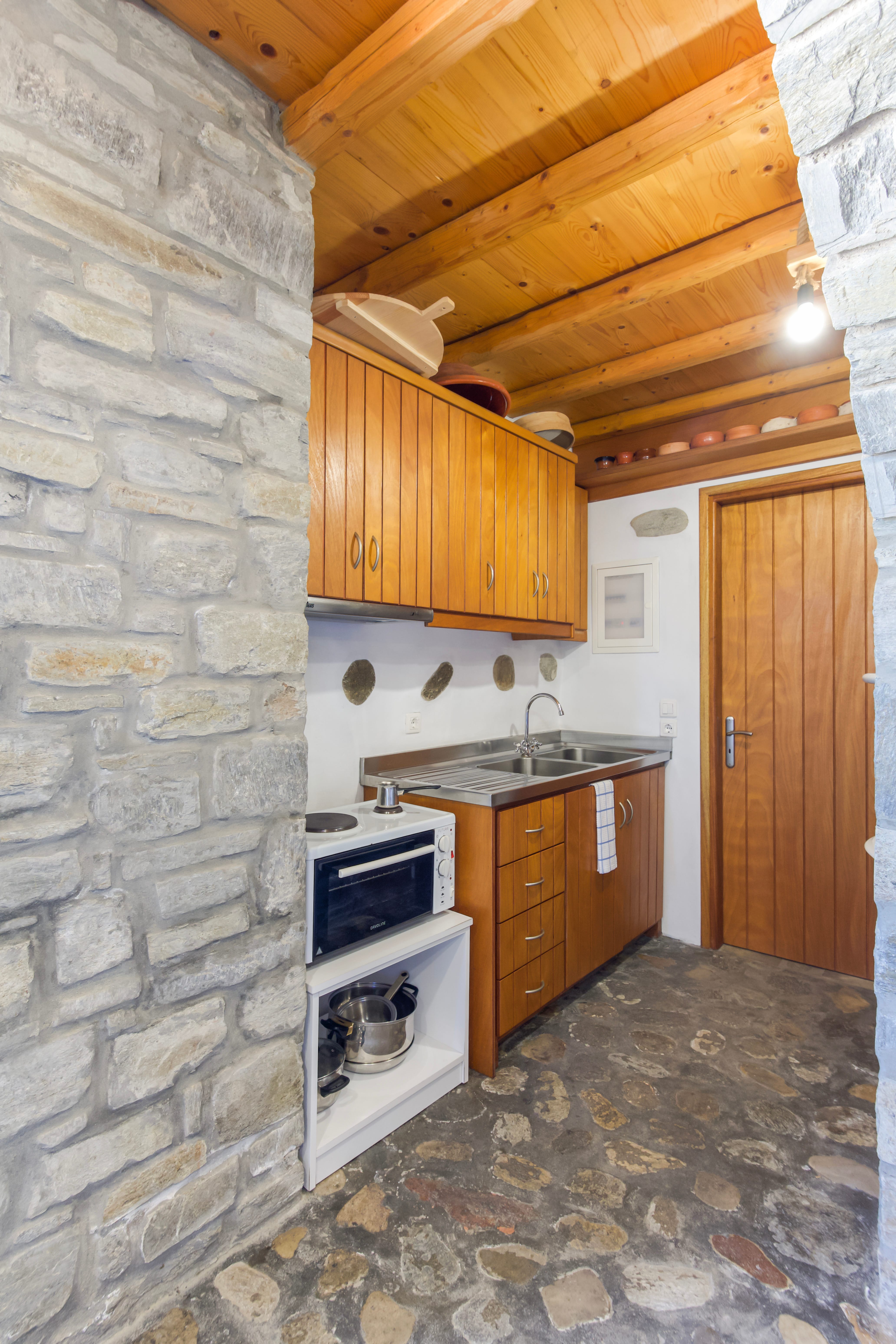 a kitchen with a stone wall