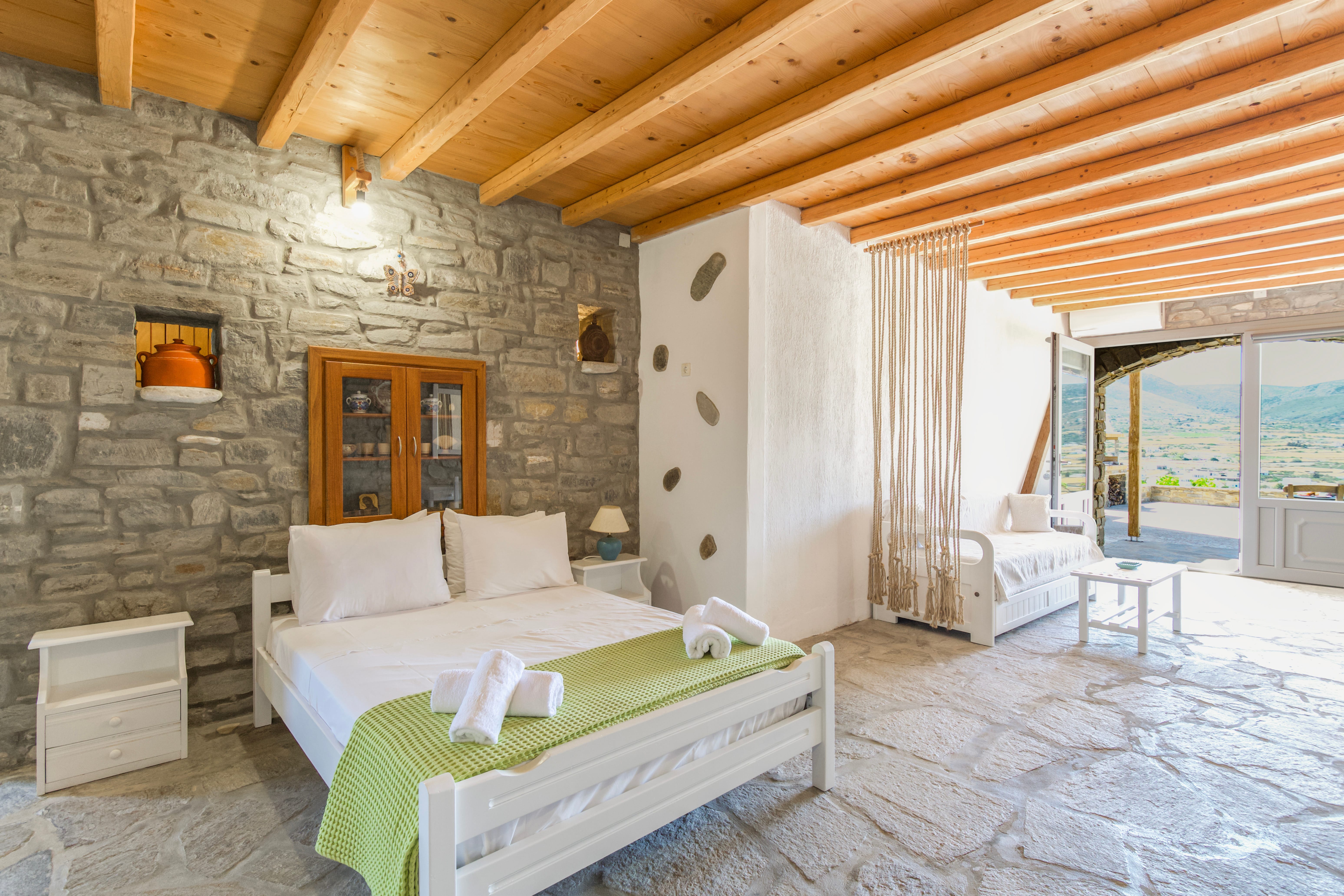 a bedroom with a stone wall