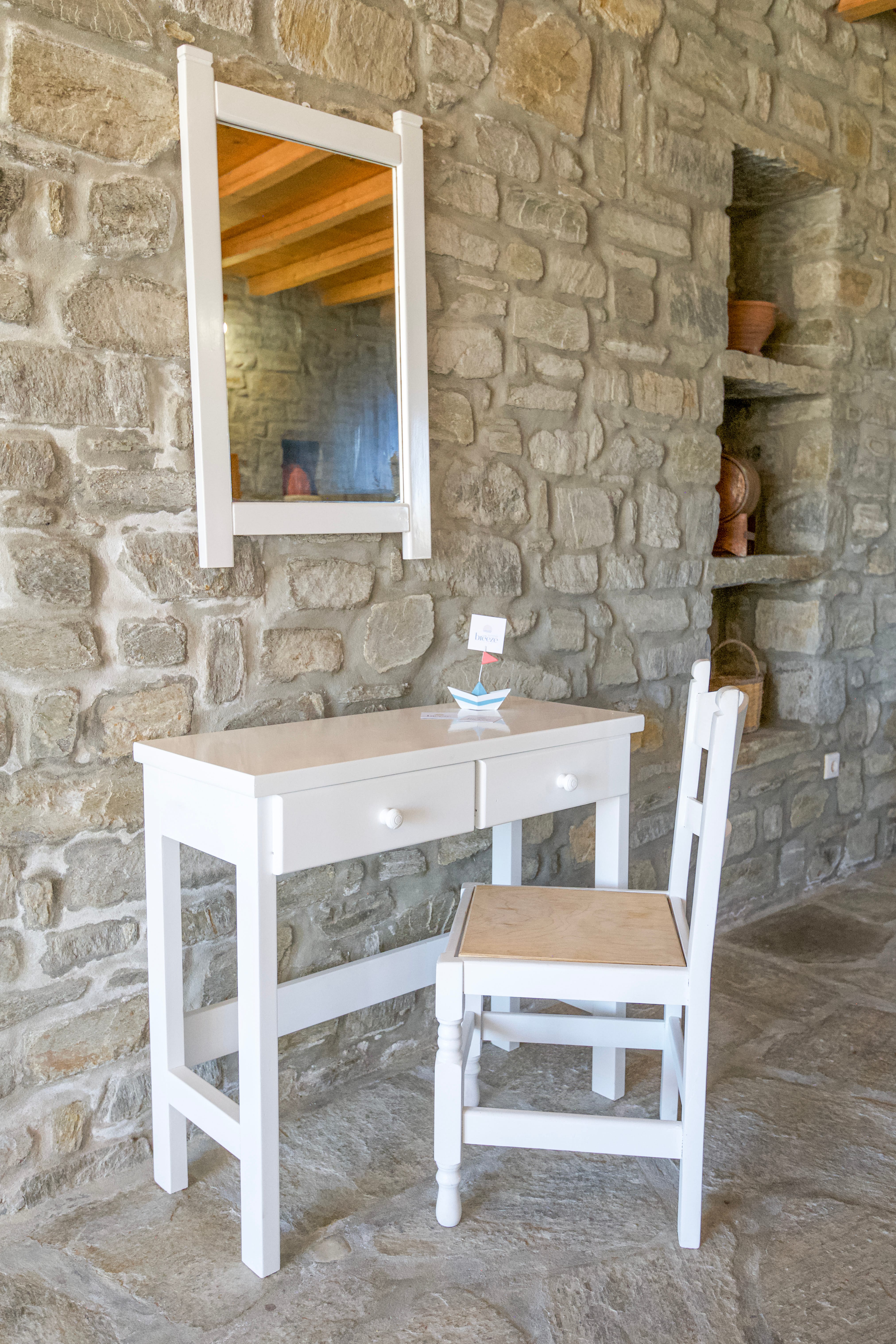 a desk and chair in a stone room