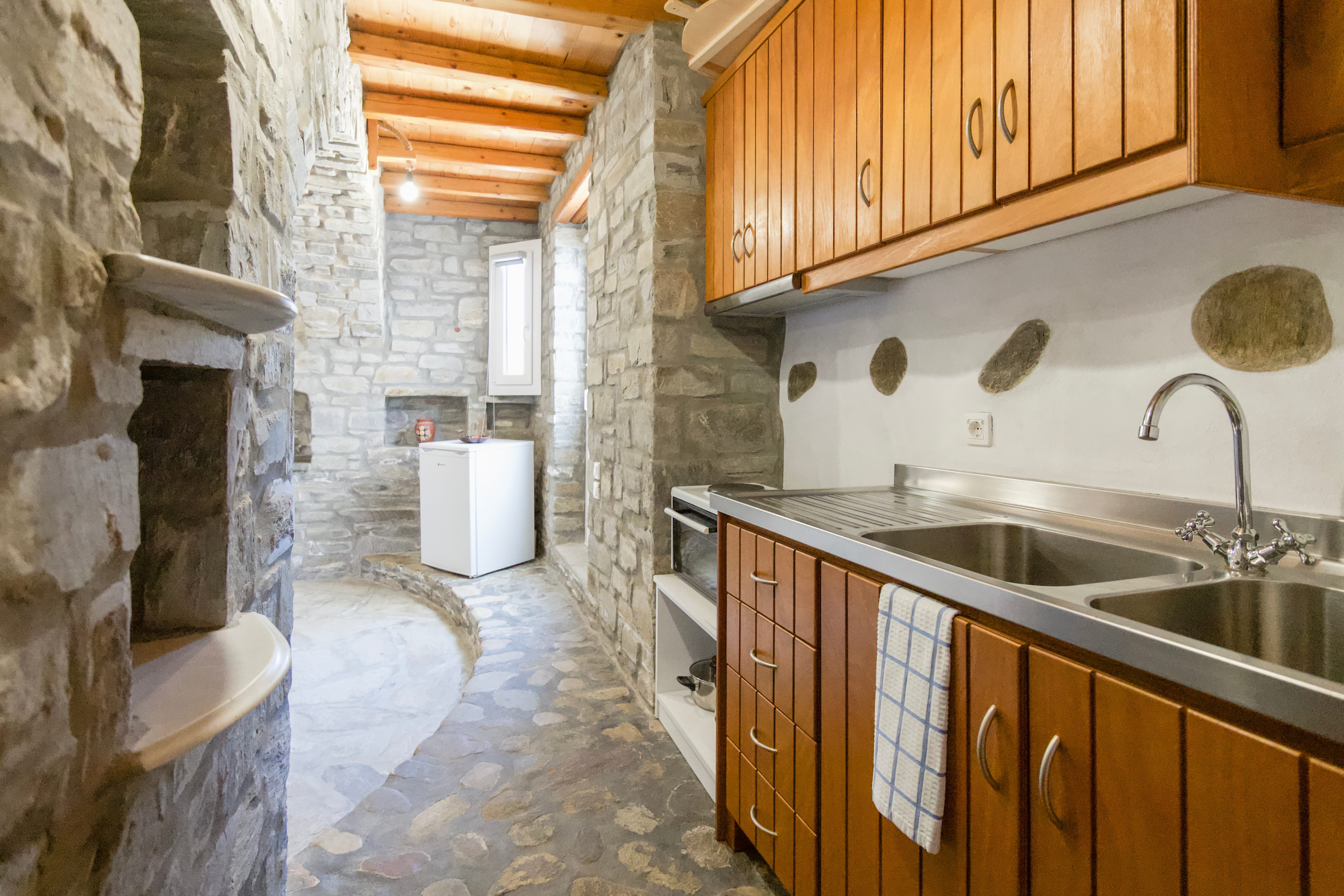 a kitchen with wooden cabinets