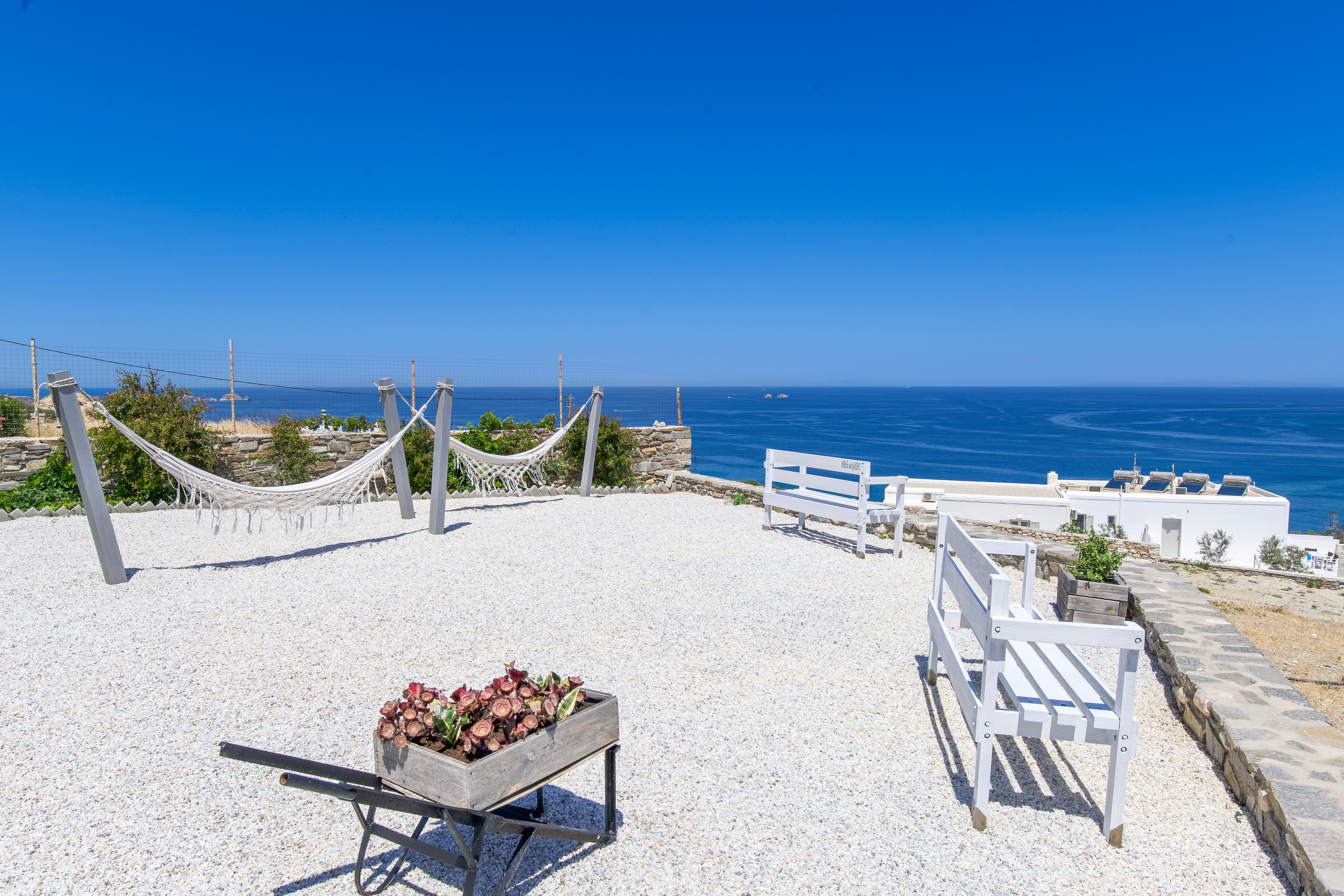 a beach with chairs and tables
