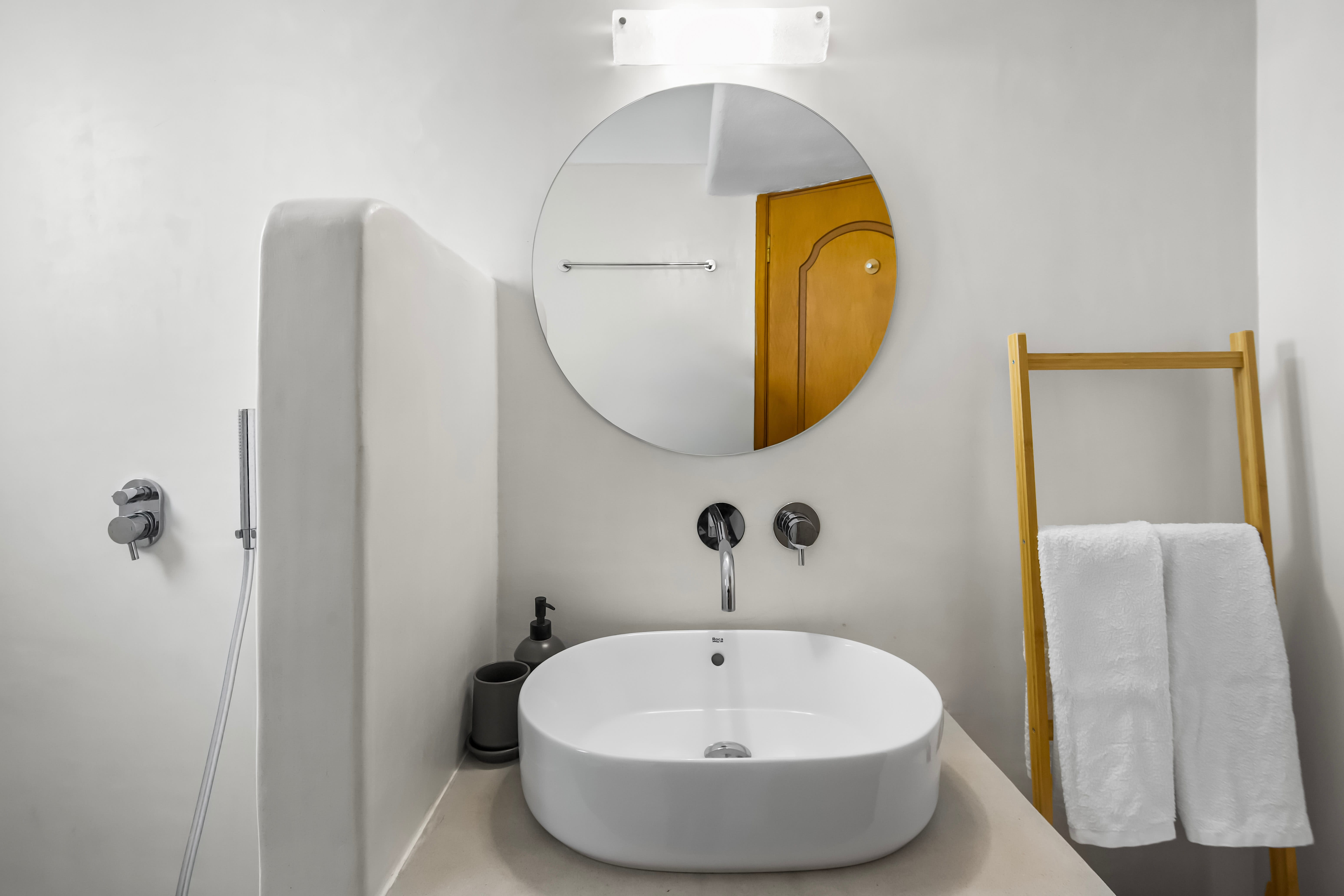 a bathroom with a round mirror