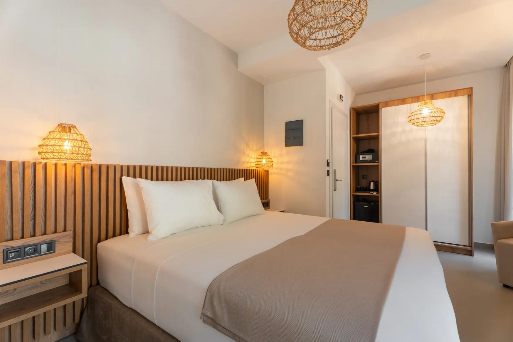 a bedroom with a bed and lamps