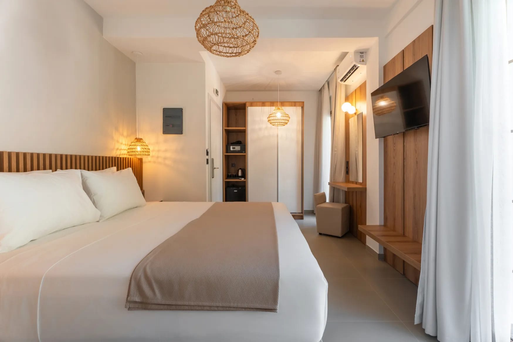 a hotel room with a bed and a television