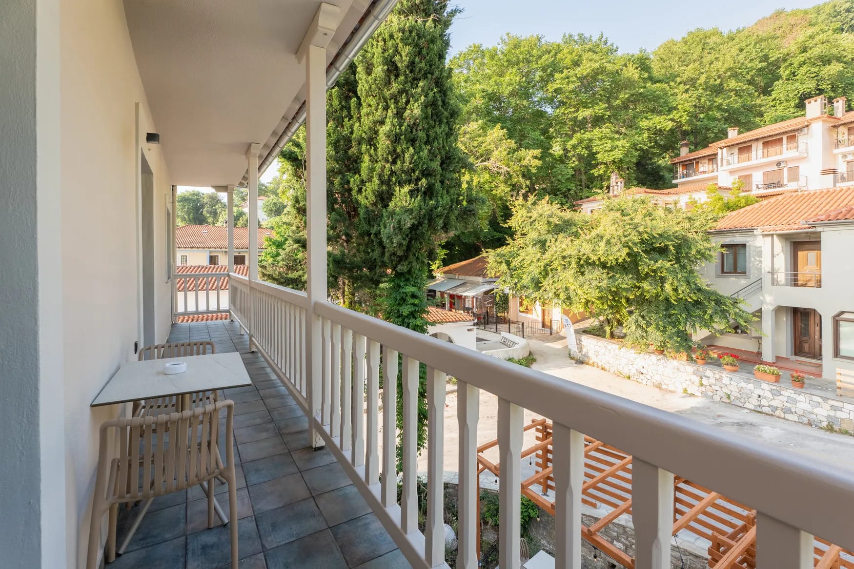 a deck with a railing and trees