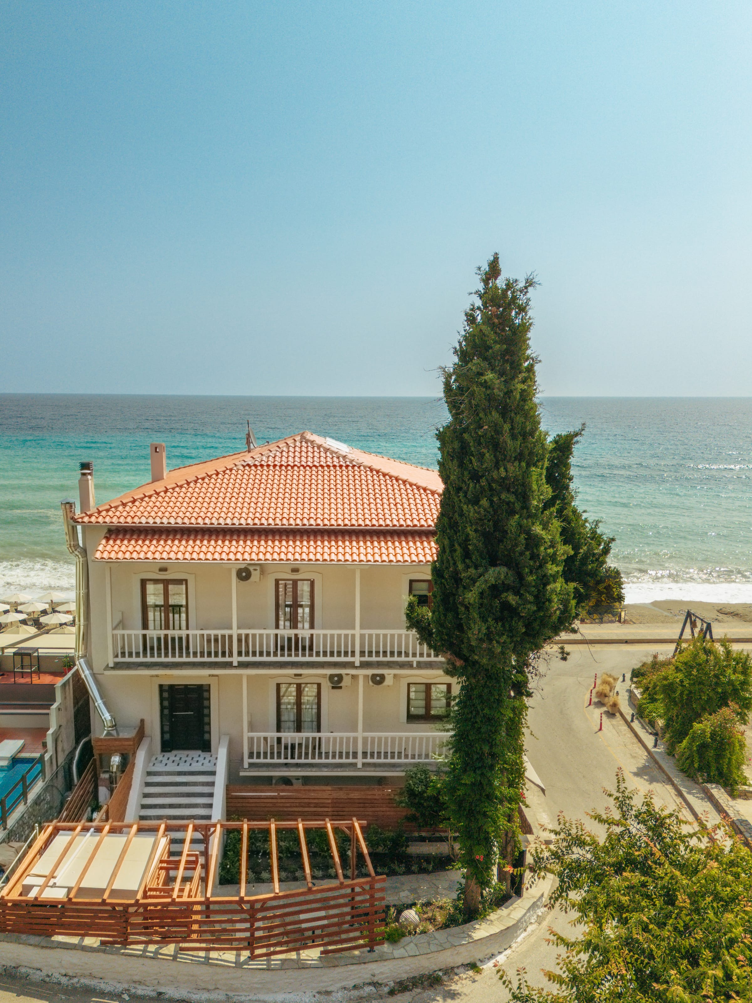 a house with a red roof by the ocean