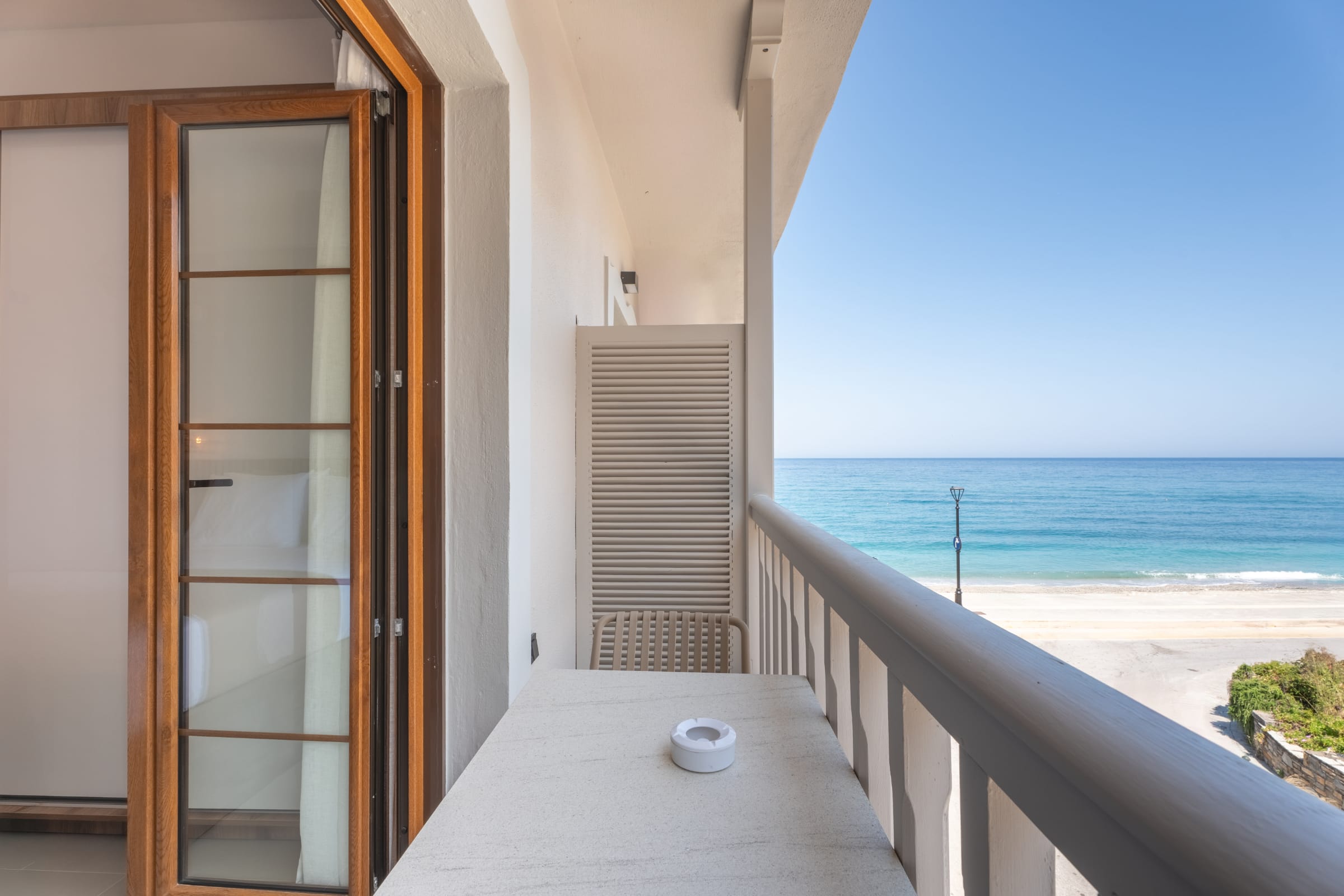 a table and a door next to a beach