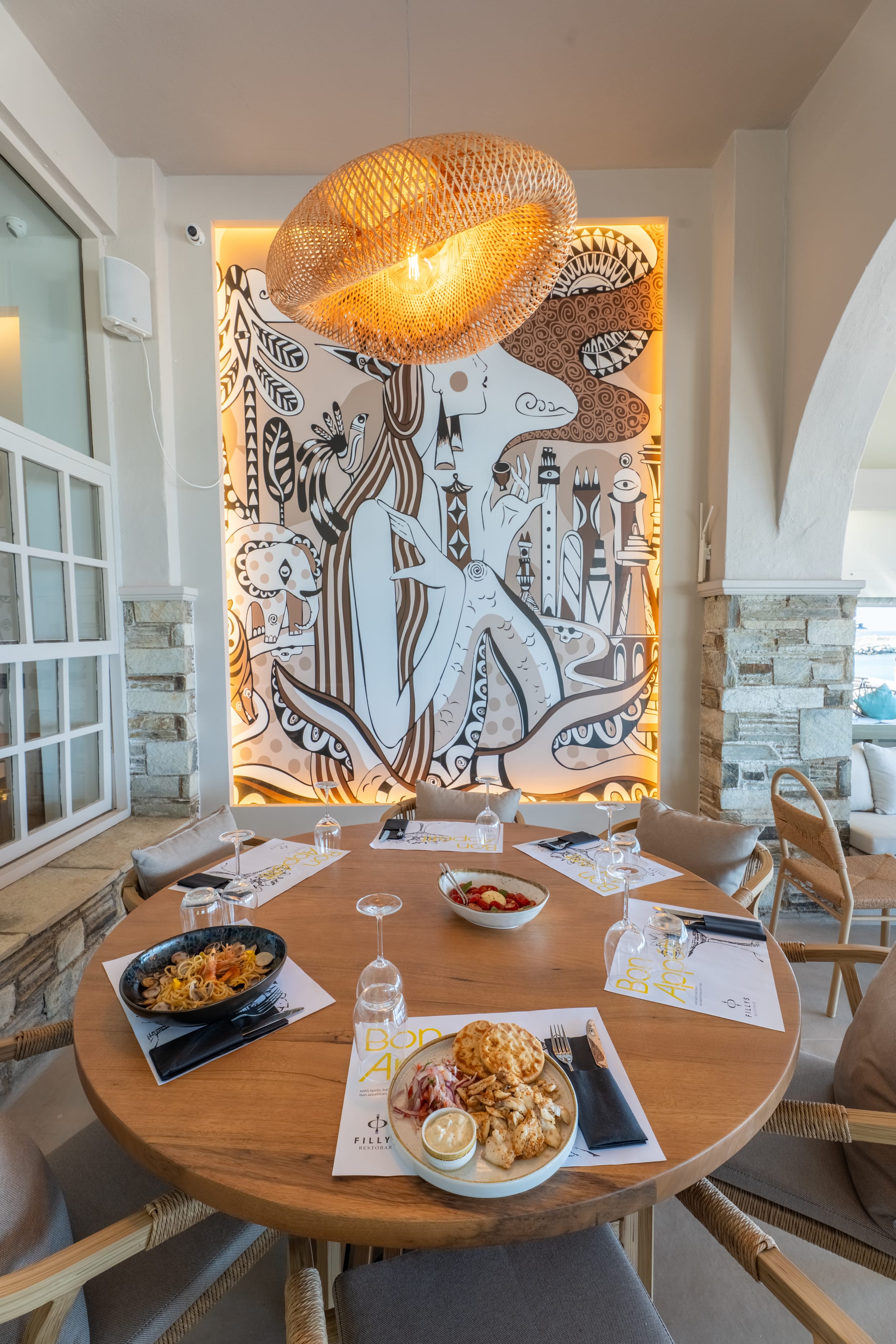 a table with food and a painting on the wall