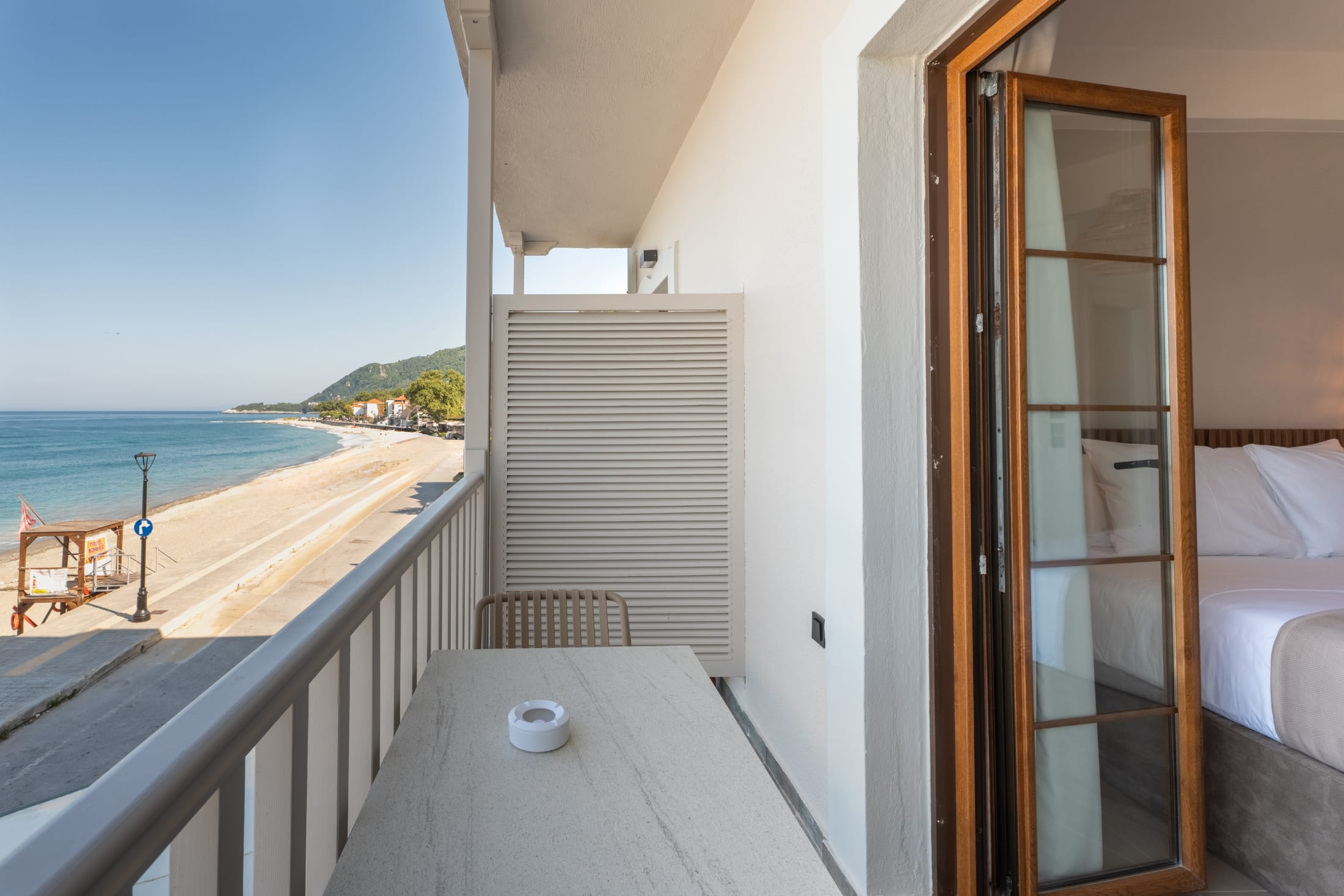 a balcony with a table and chairs