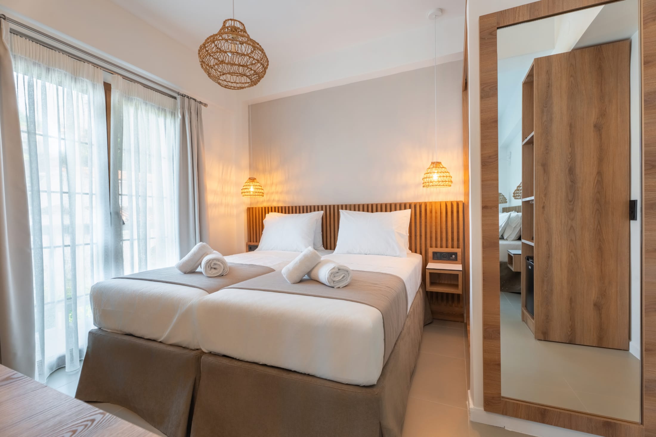 a hotel room with a bed and a lamp