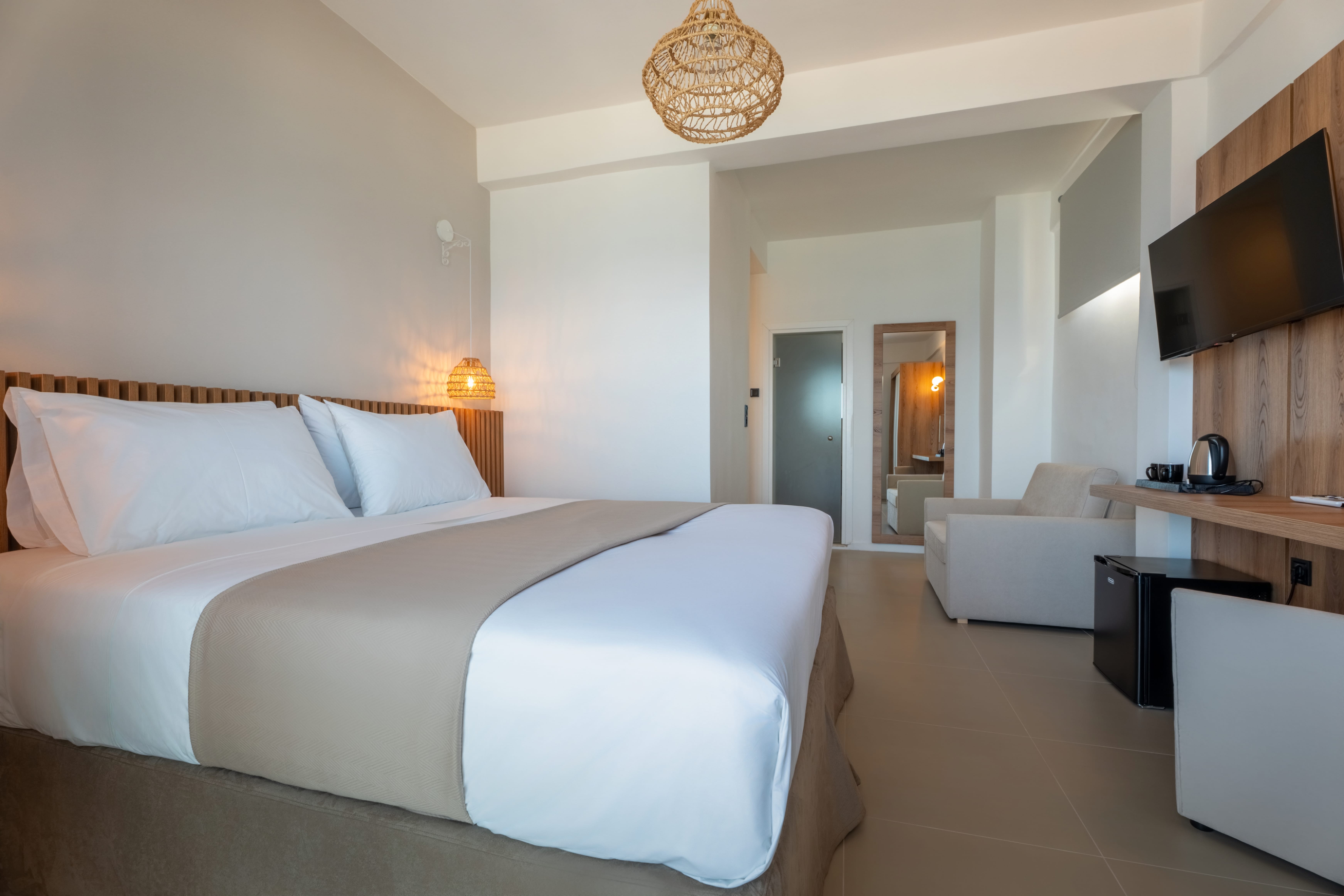 a hotel room with a bed and a tv