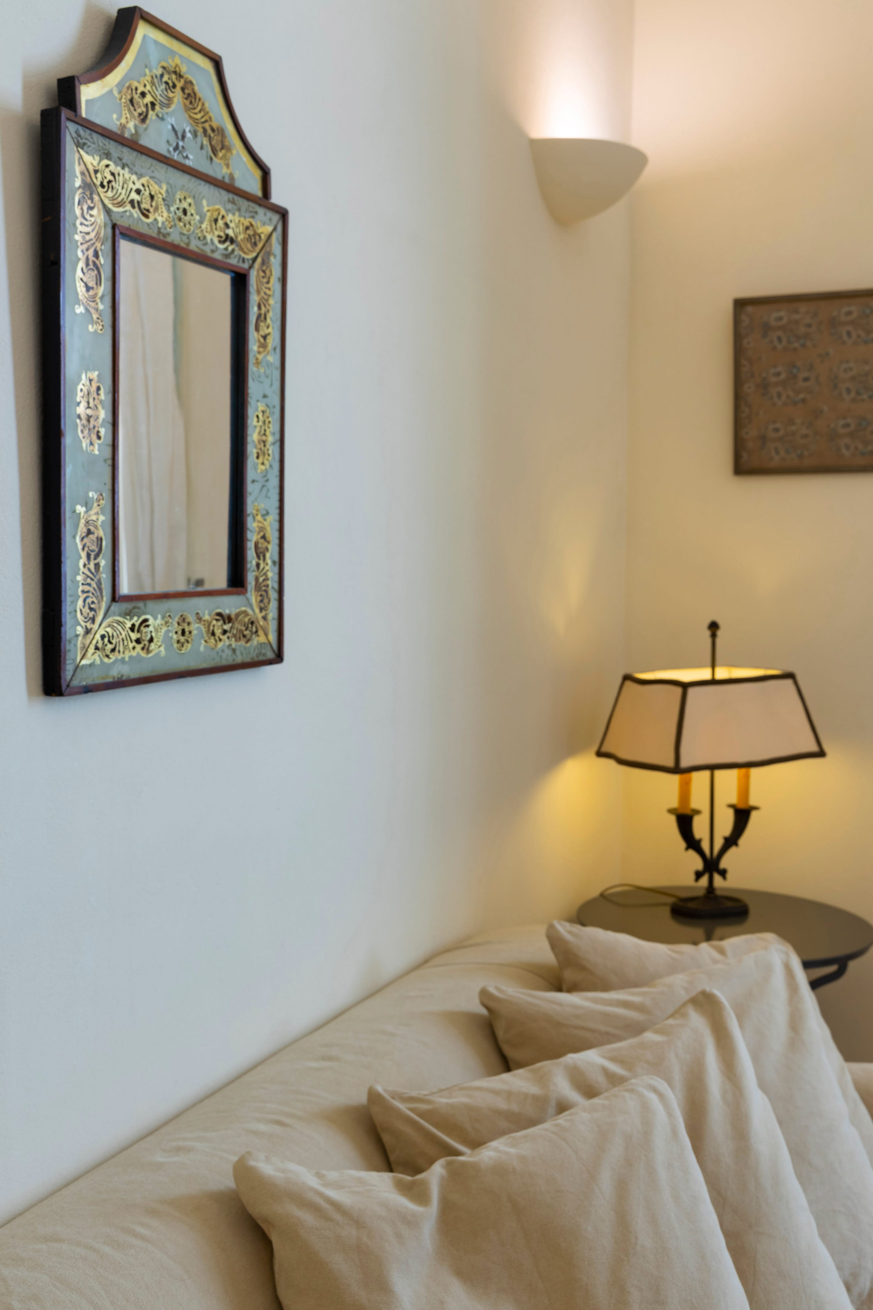 a bed with a mirror on the wall