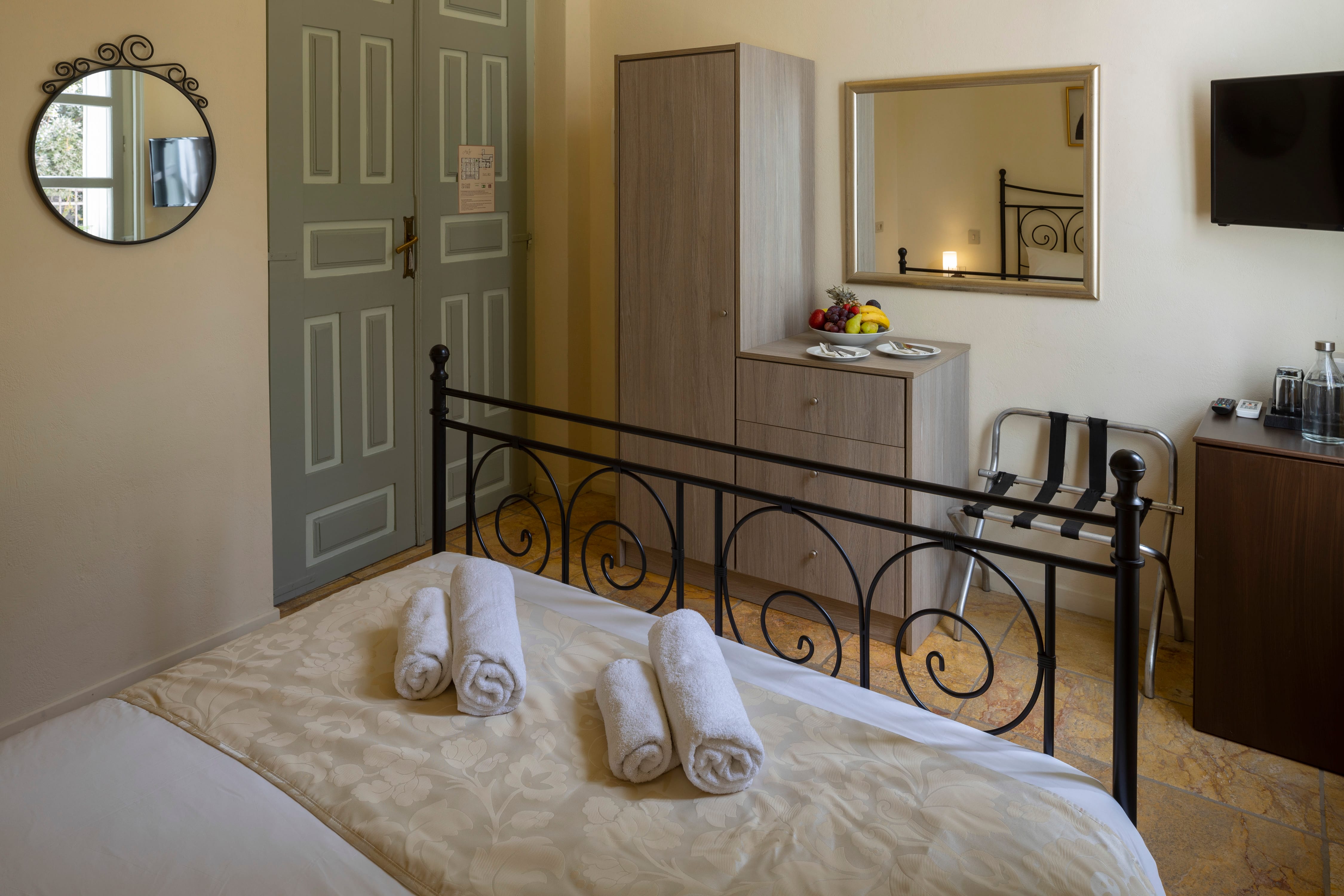 a bed with white sheets and pillows