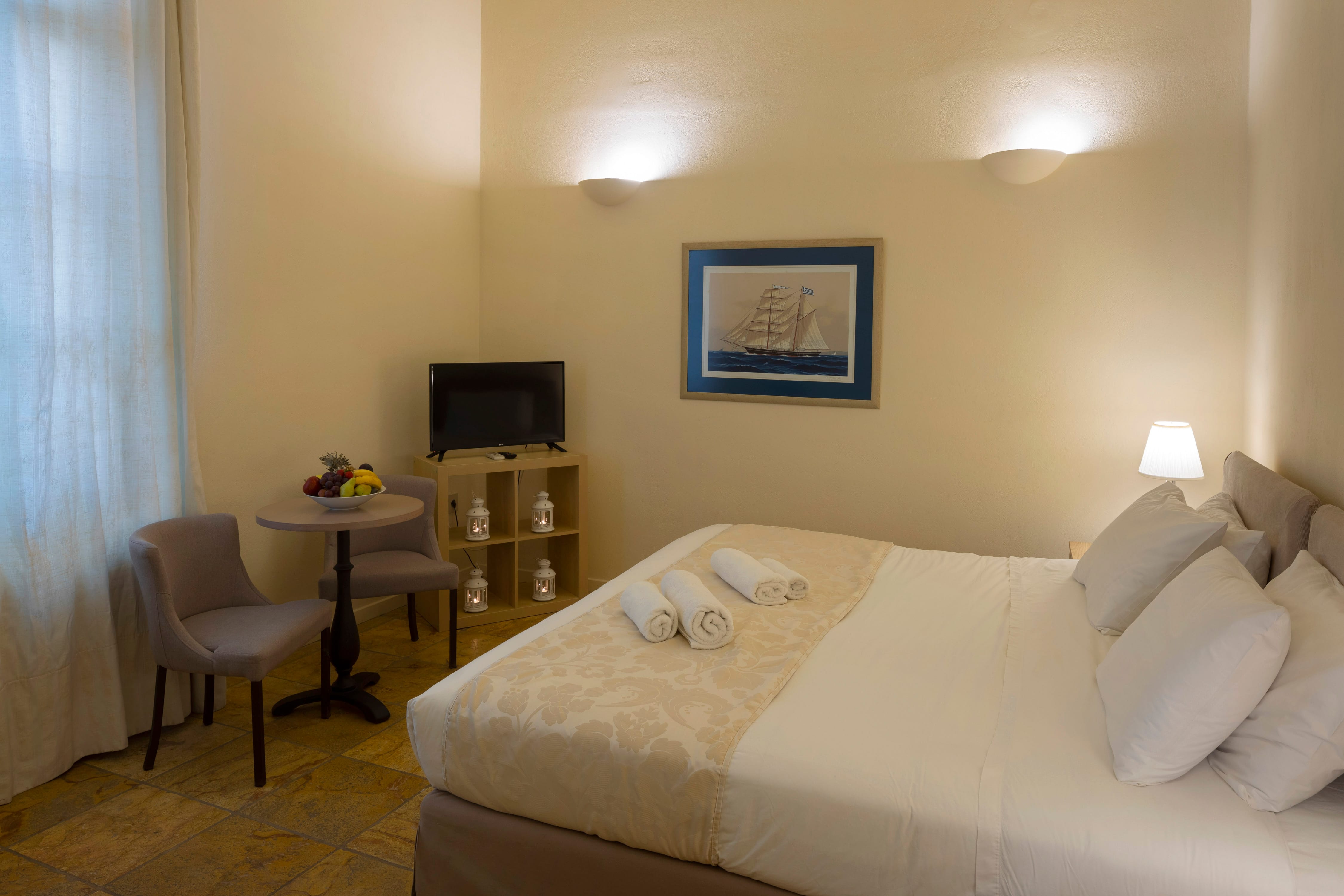 a hotel room with a bed and a television