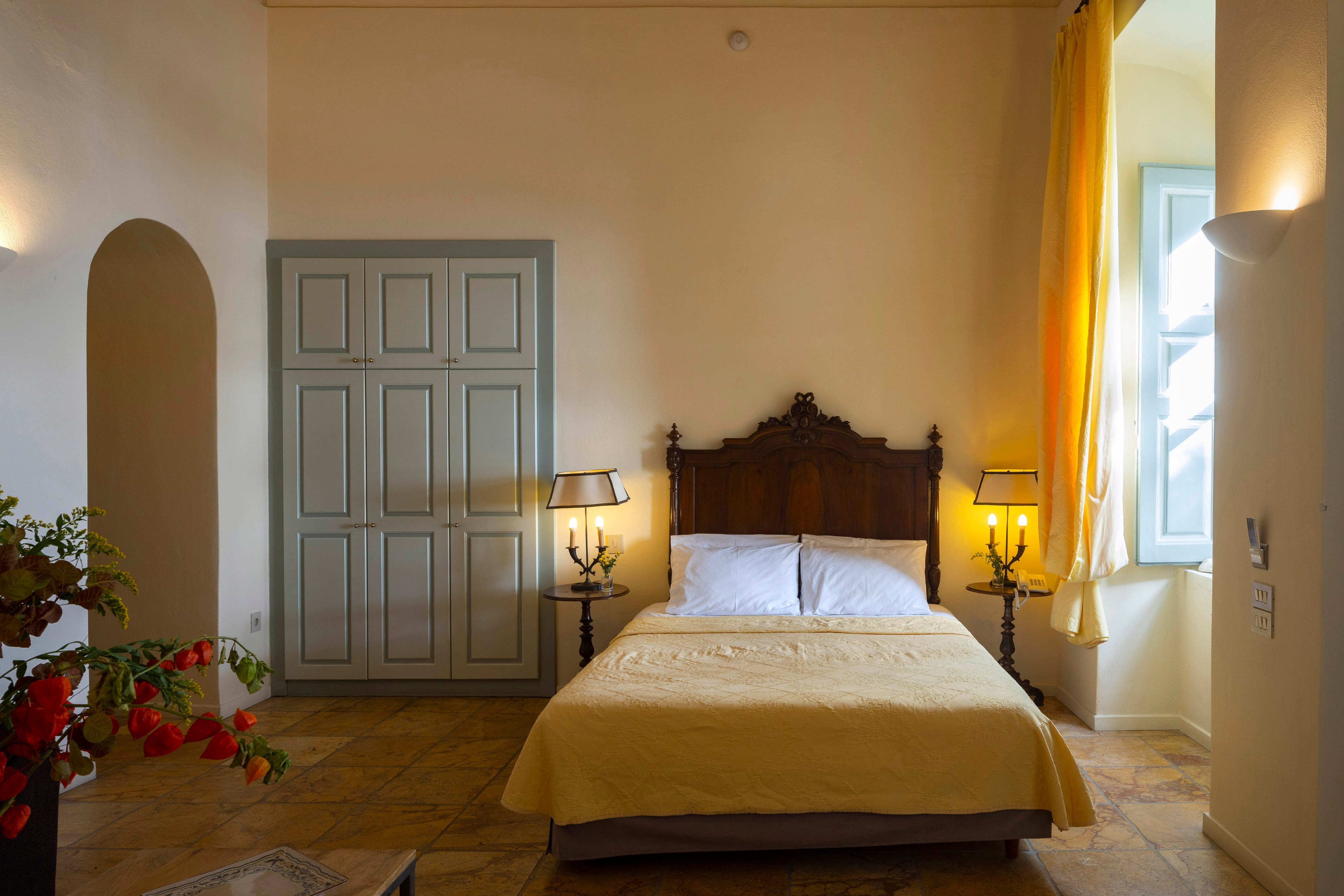 a bedroom with a bed and lamps